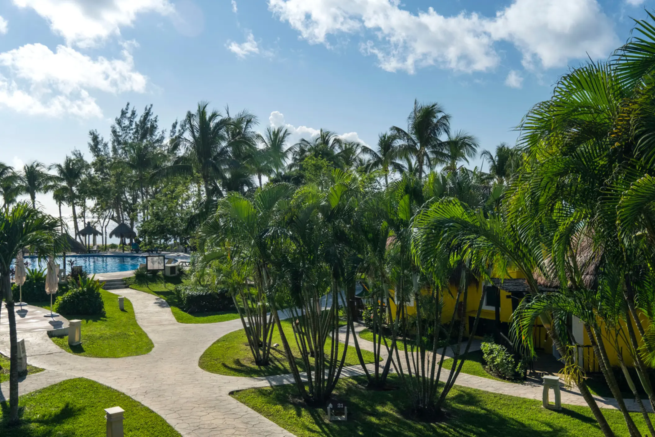 Lush tropical gardens and stone pathways at Iberostar Waves Cozumel, Cozumel