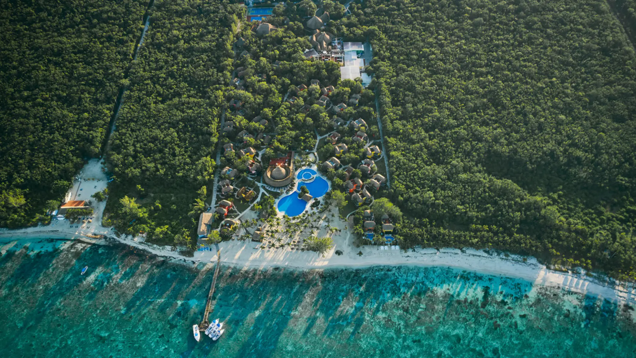 Aerial view of Iberostar Waves Cozumel beach, pools and surrounding jungle, Cozumel