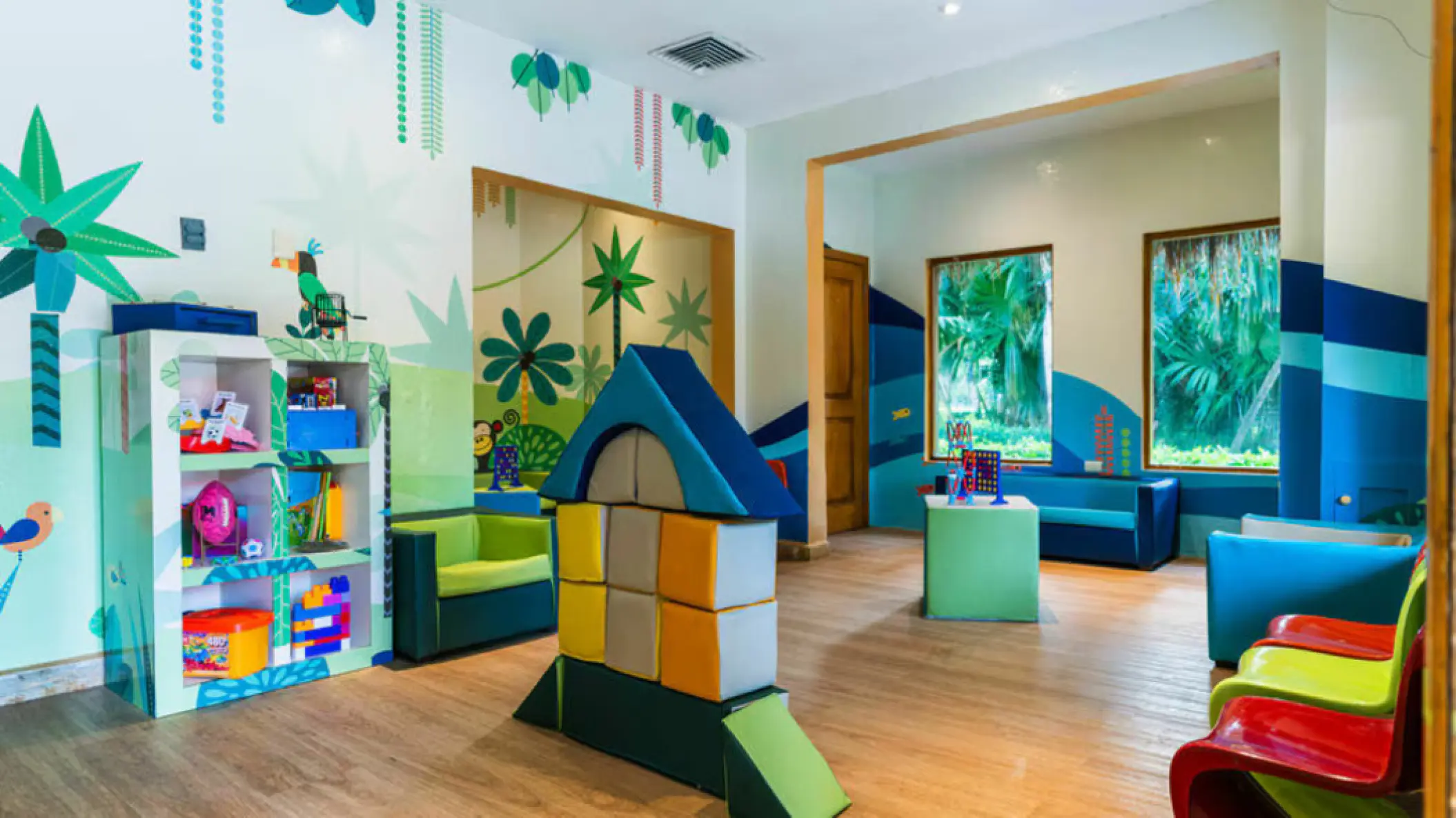 Kids club with colorful toys and jungle-themed murals at Iberostar Waves Cozumel