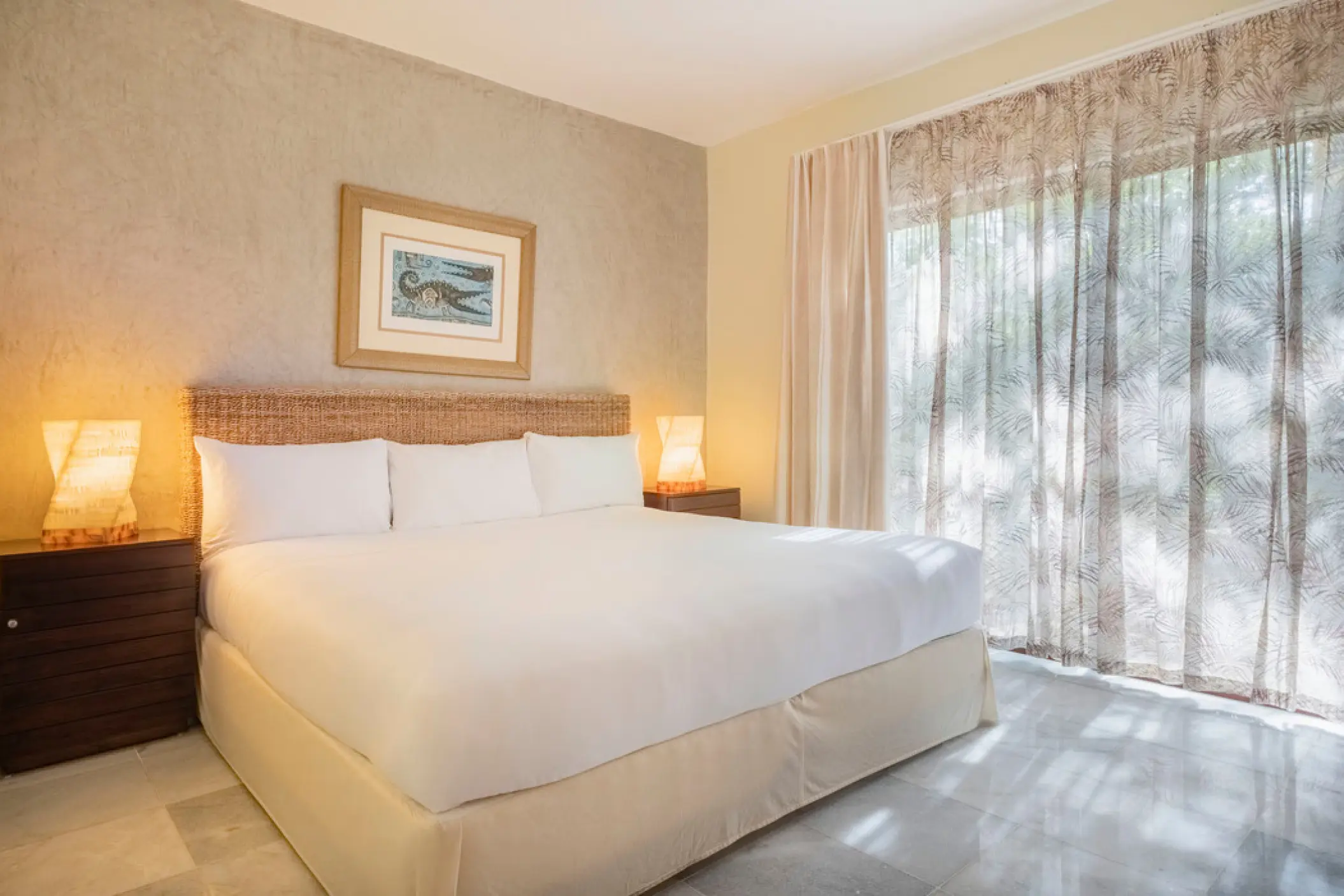 Iberostar Waves Cozumel suite with a king-size bed and wicker headboard, Cozumel