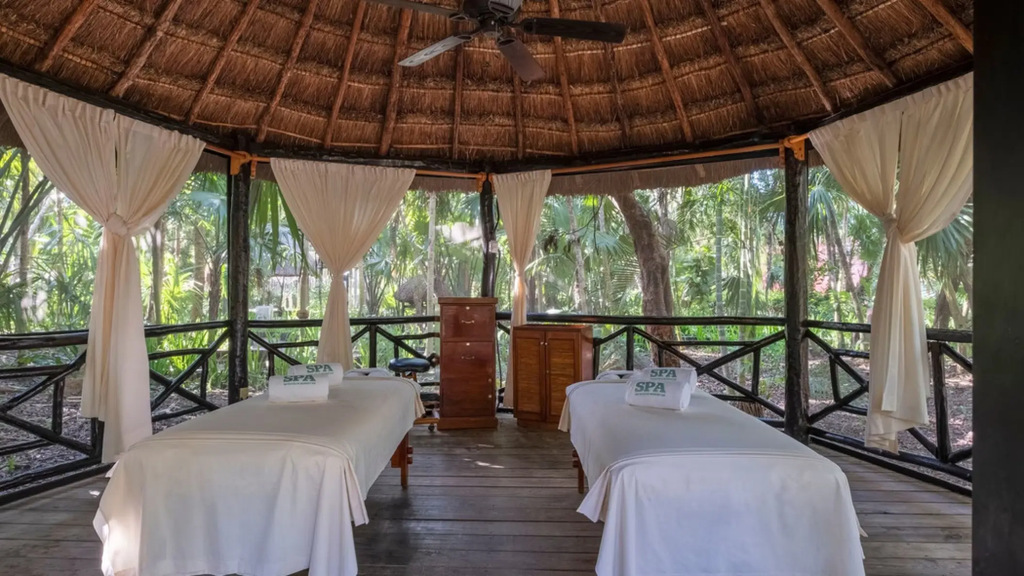 Outdoor spa palapa with two massage beds at Iberostar Waves Cozumel