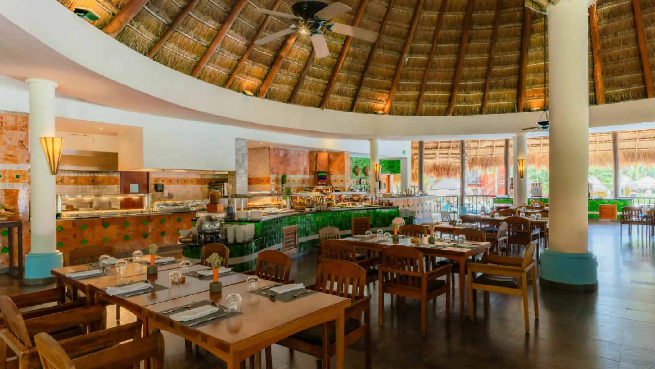 Buffet restaurant with a high thatched palapa roof at Iberostar Waves Cozumel