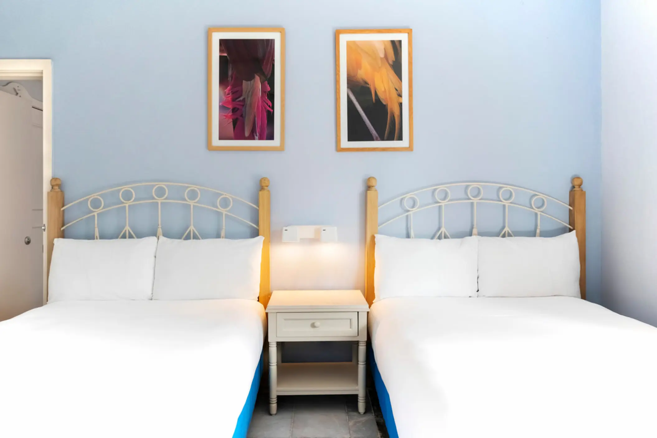 Guest room with two double beds and light blue walls at Iberostar Waves Cozumel