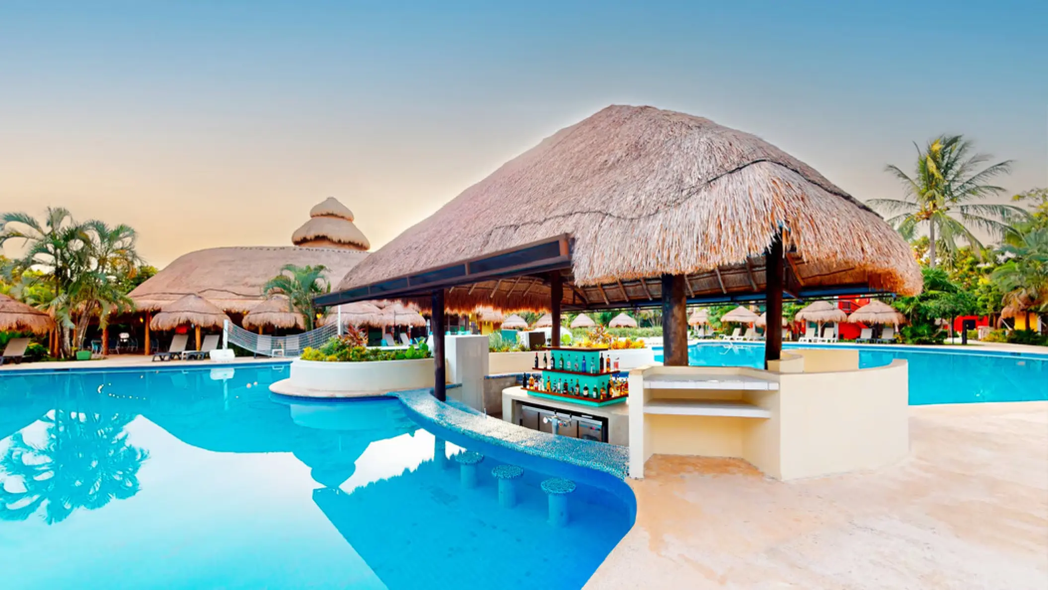 Swim-up bar with a thatched palapa roof at Iberostar Waves Cozumel
