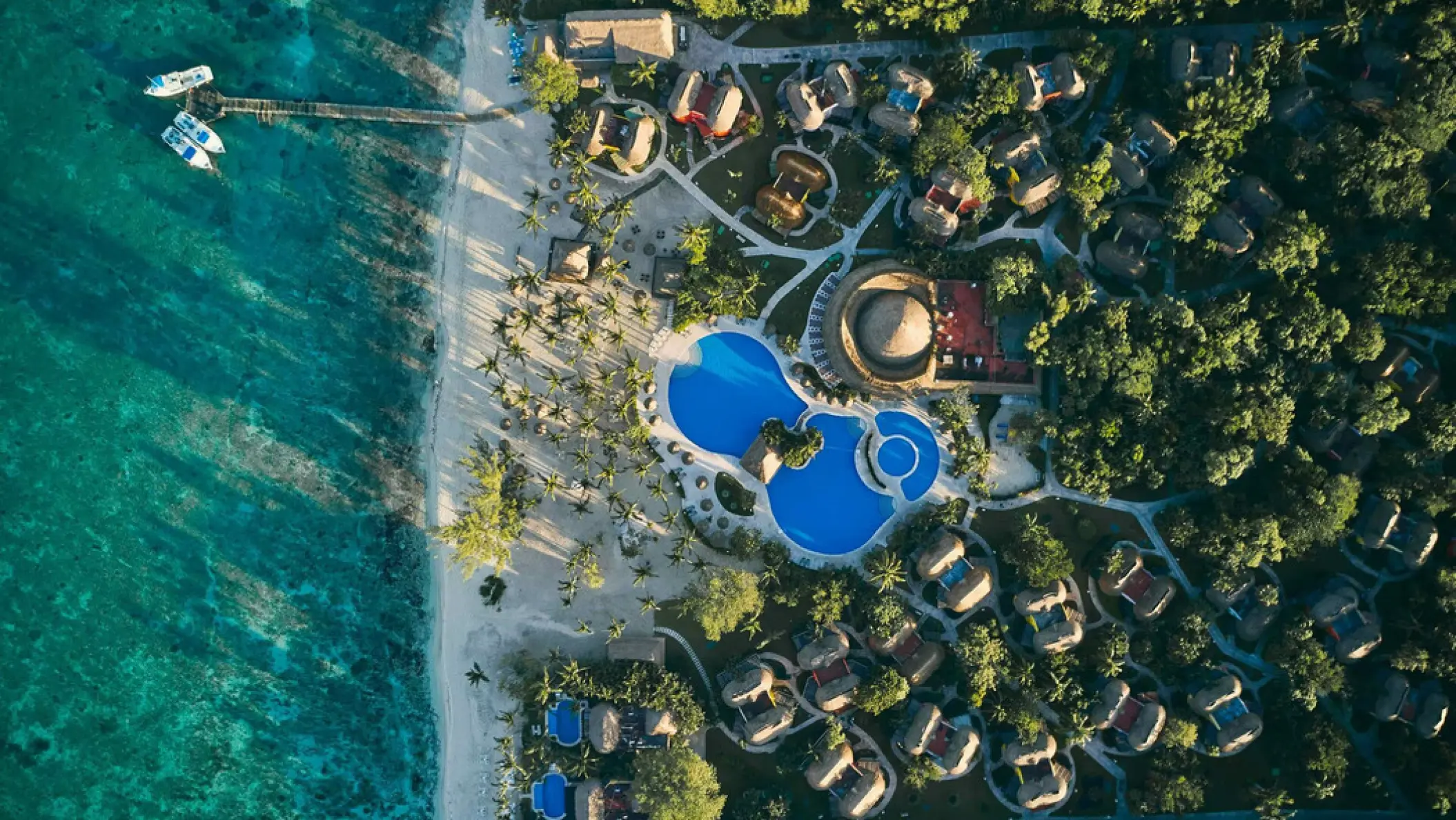 Aerial view of Iberostar Waves Cozumel pools and bungalows along the beach, Cozumel