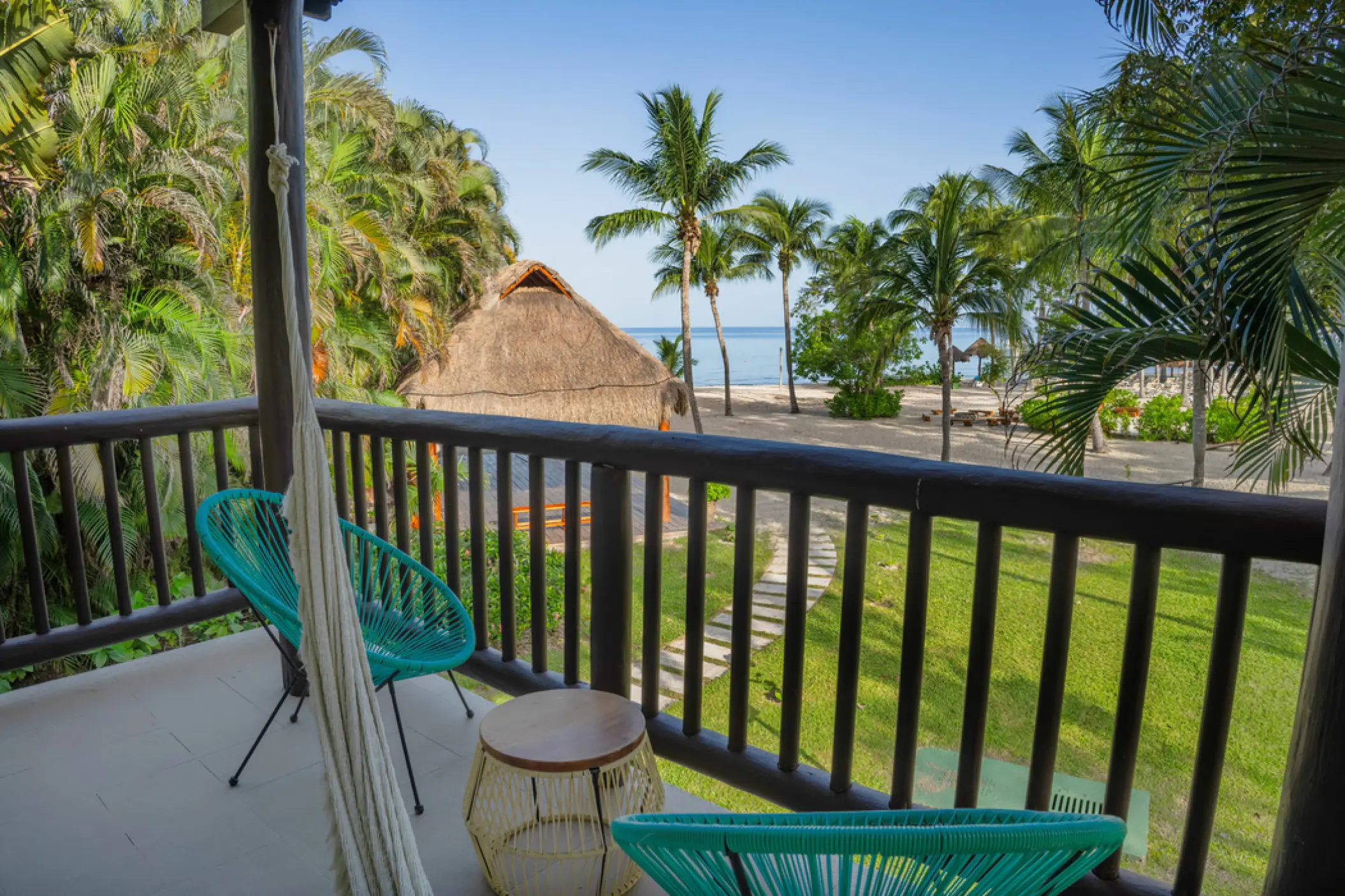 Iberostar Waves Cozumel suite balcony with hammock and chairs overlooking the beach, Cozumel