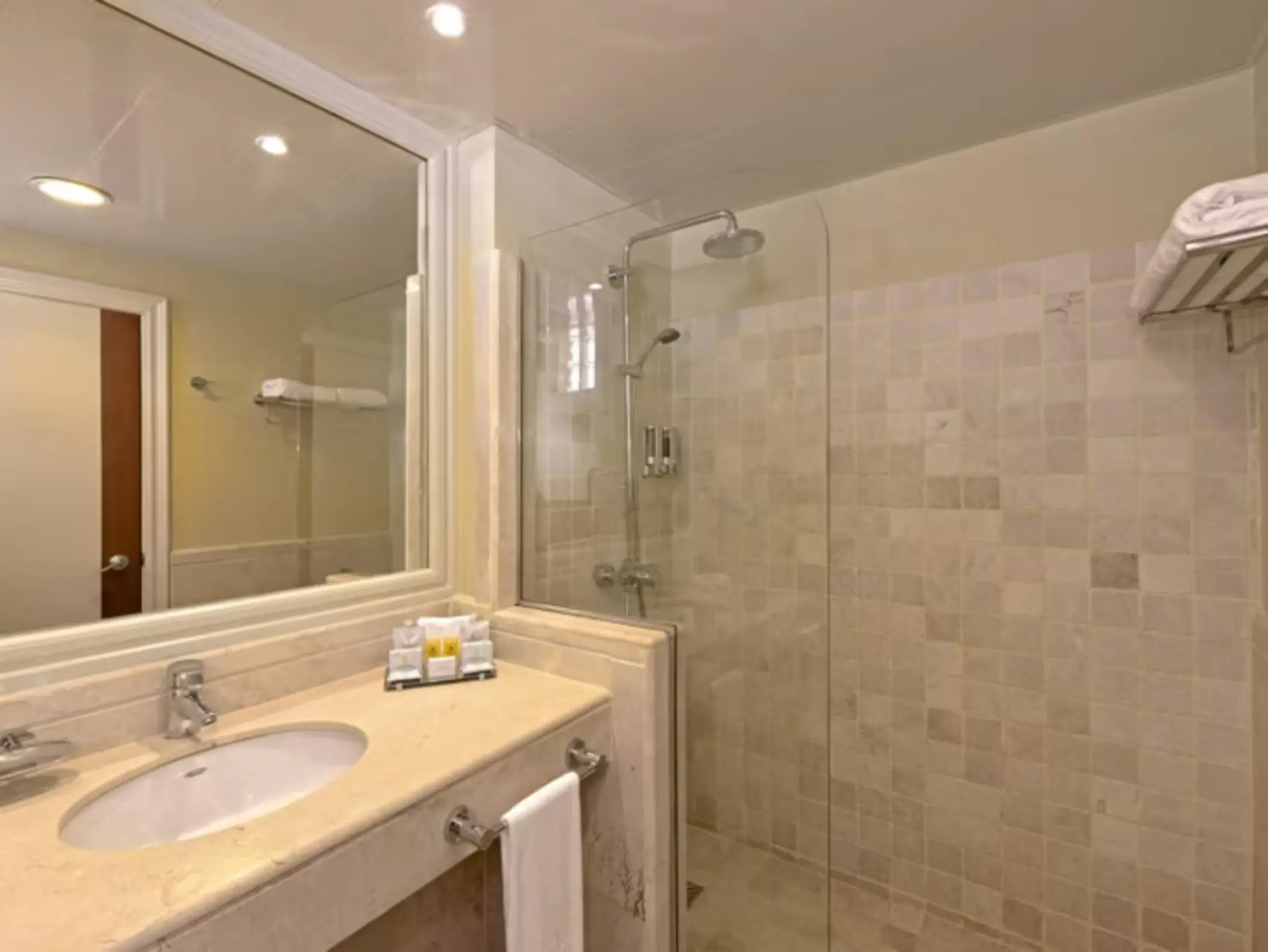 Modern bathroom with a walk-in tile shower and vanity at Iberostar Waves Dominicana, Punta Cana