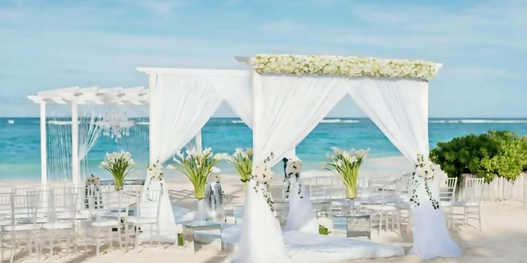 Beachfront wedding ceremony setup under white draped gazebos at Iberostar Waves Dominicana, Punta Cana