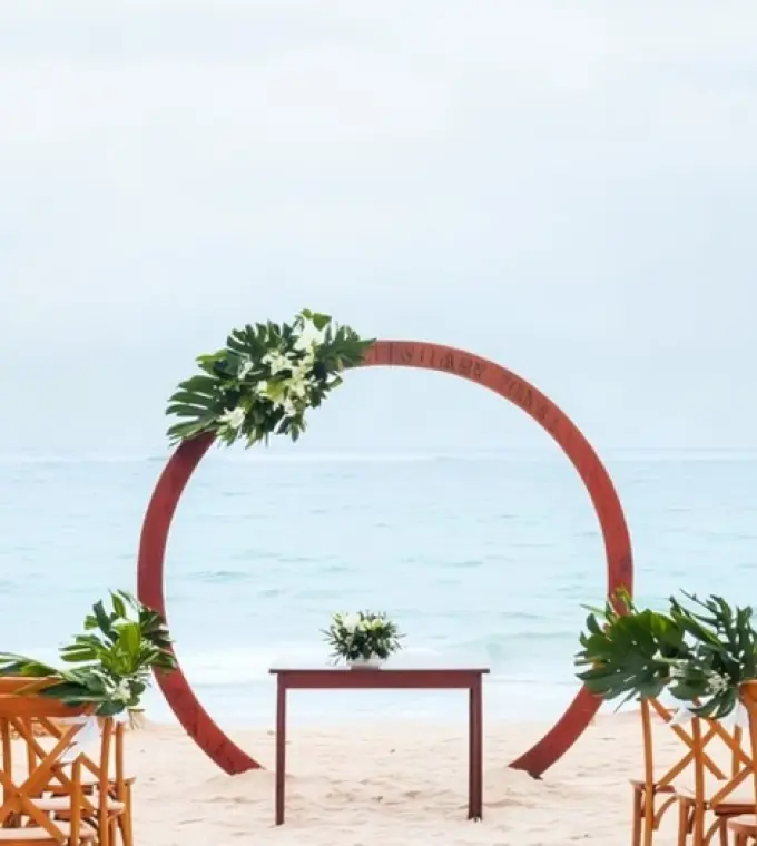 Beachfront wedding ceremony with circular wood arch at Iberostar Waves Dominicana, Punta Cana