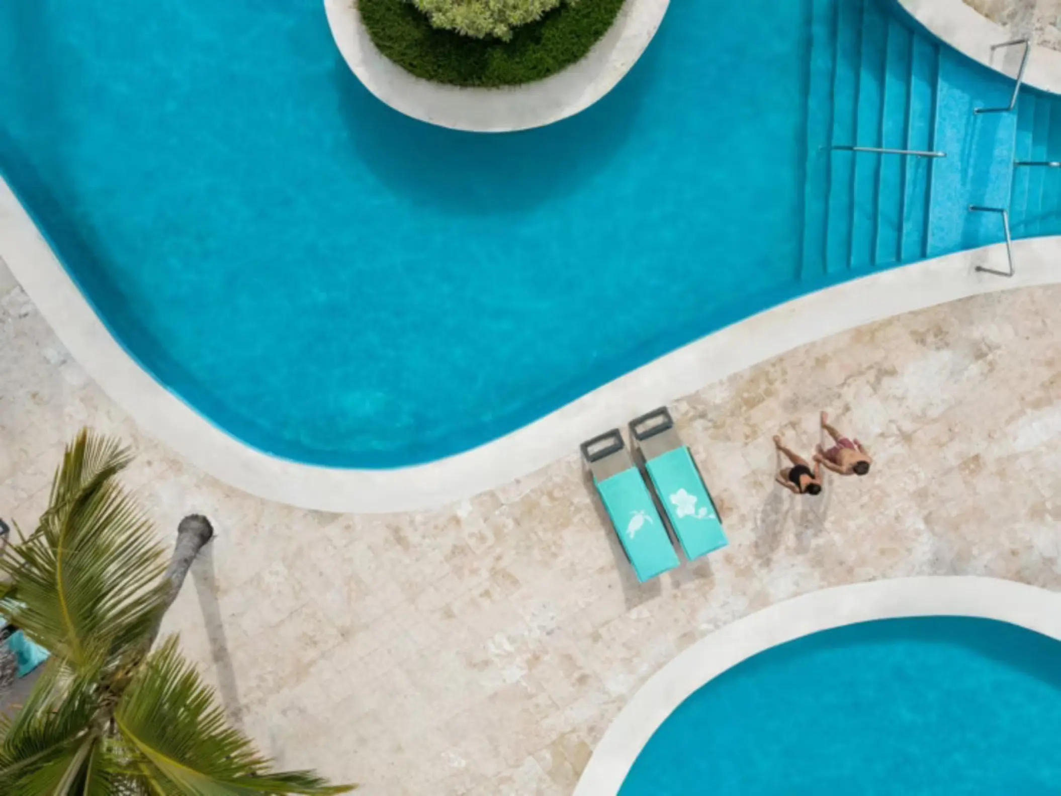 Aerial view of a couple relaxing by the swimming pool at Iberostar Waves Dominicana, Punta Cana