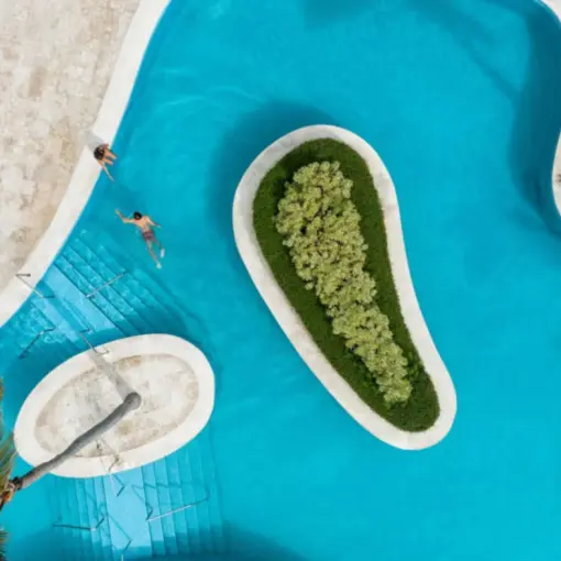Aerial view of a couple swimming in the turquoise winding pool at Iberostar Waves Dominicana, Punta Cana