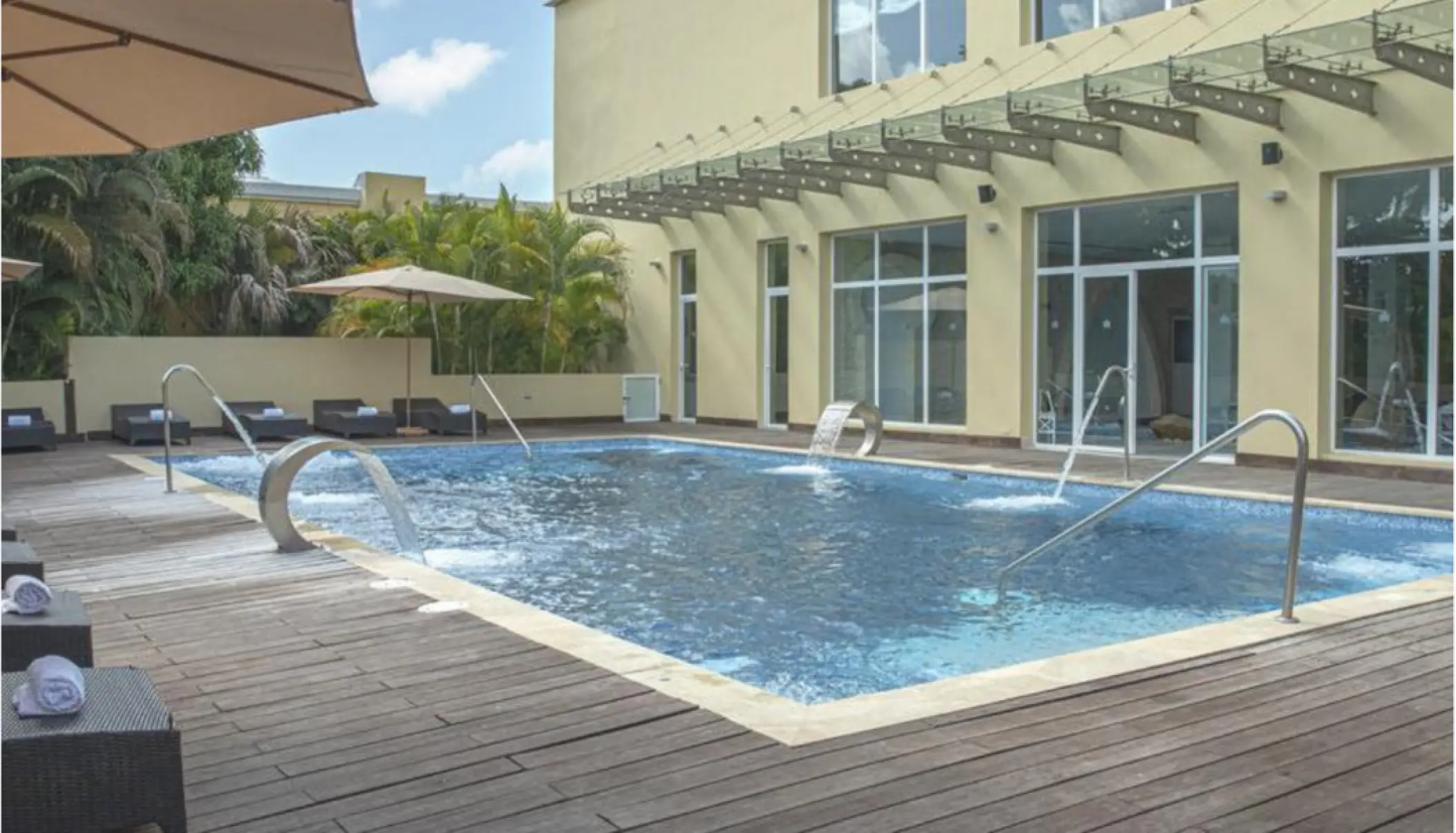 Outdoor spa pool with water fountains and wooden deck at Iberostar Waves Dominicana, Punta Cana
