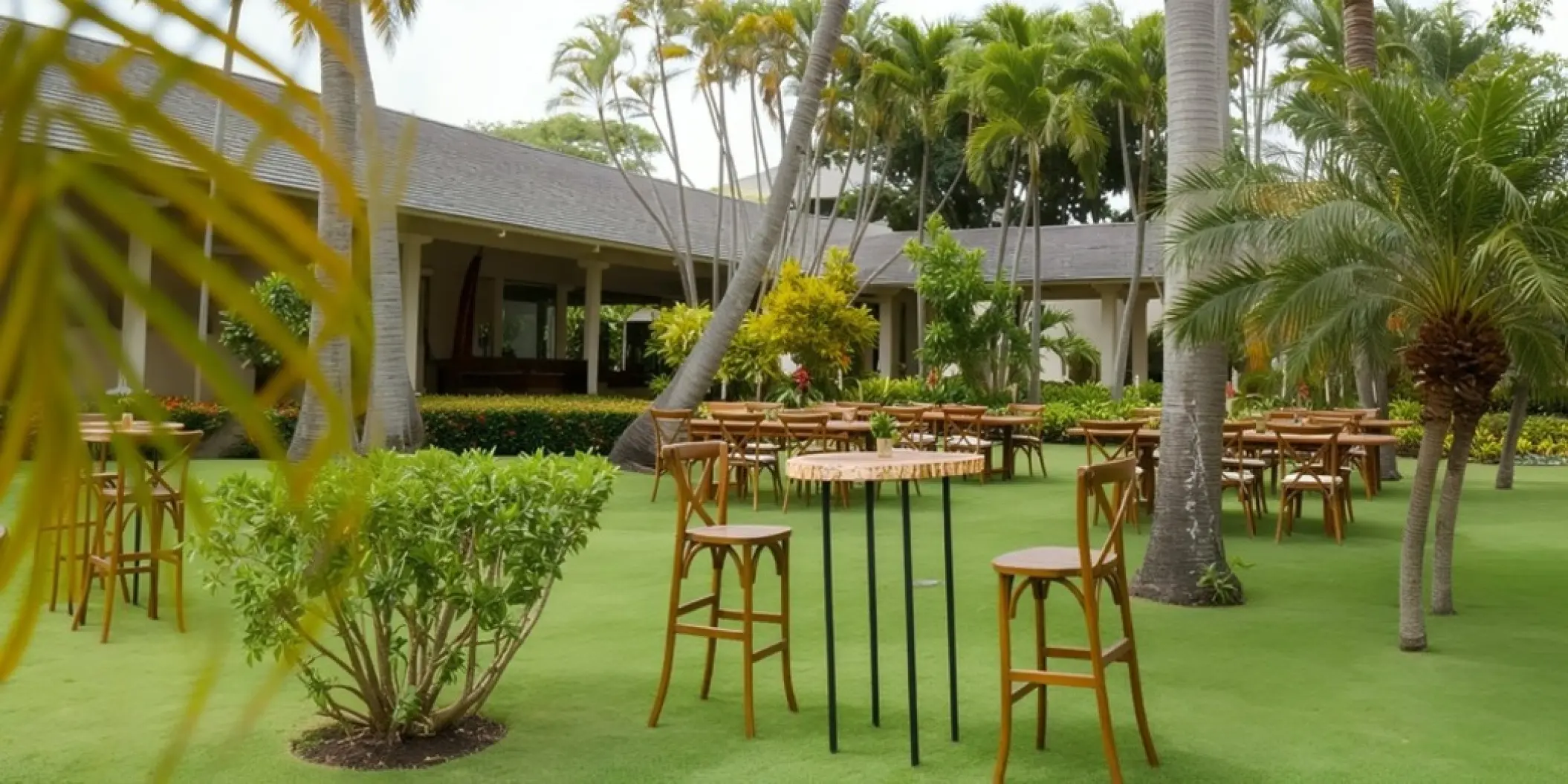 Garden wedding reception setup with wooden high-top tables at Iberostar Waves Dominicana, Punta Cana