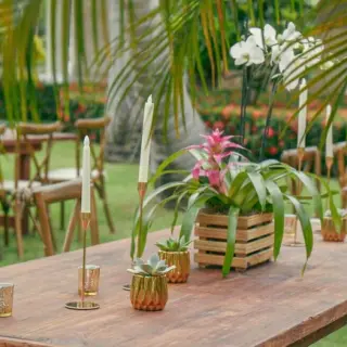 Garden wedding reception tables with tropical floral centerpieces and candles at Iberostar Waves Dominicana, Punta Cana