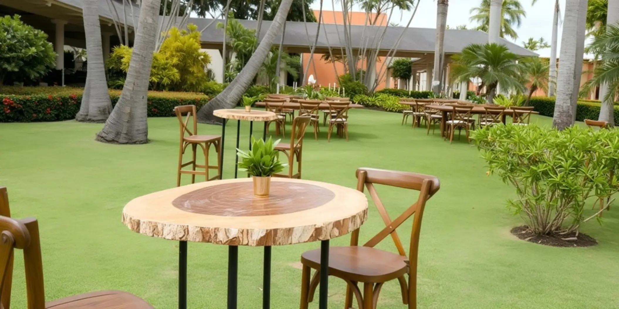 Garden wedding reception with wooden tables and cross-back chairs at Iberostar Waves Dominicana, Punta Cana
