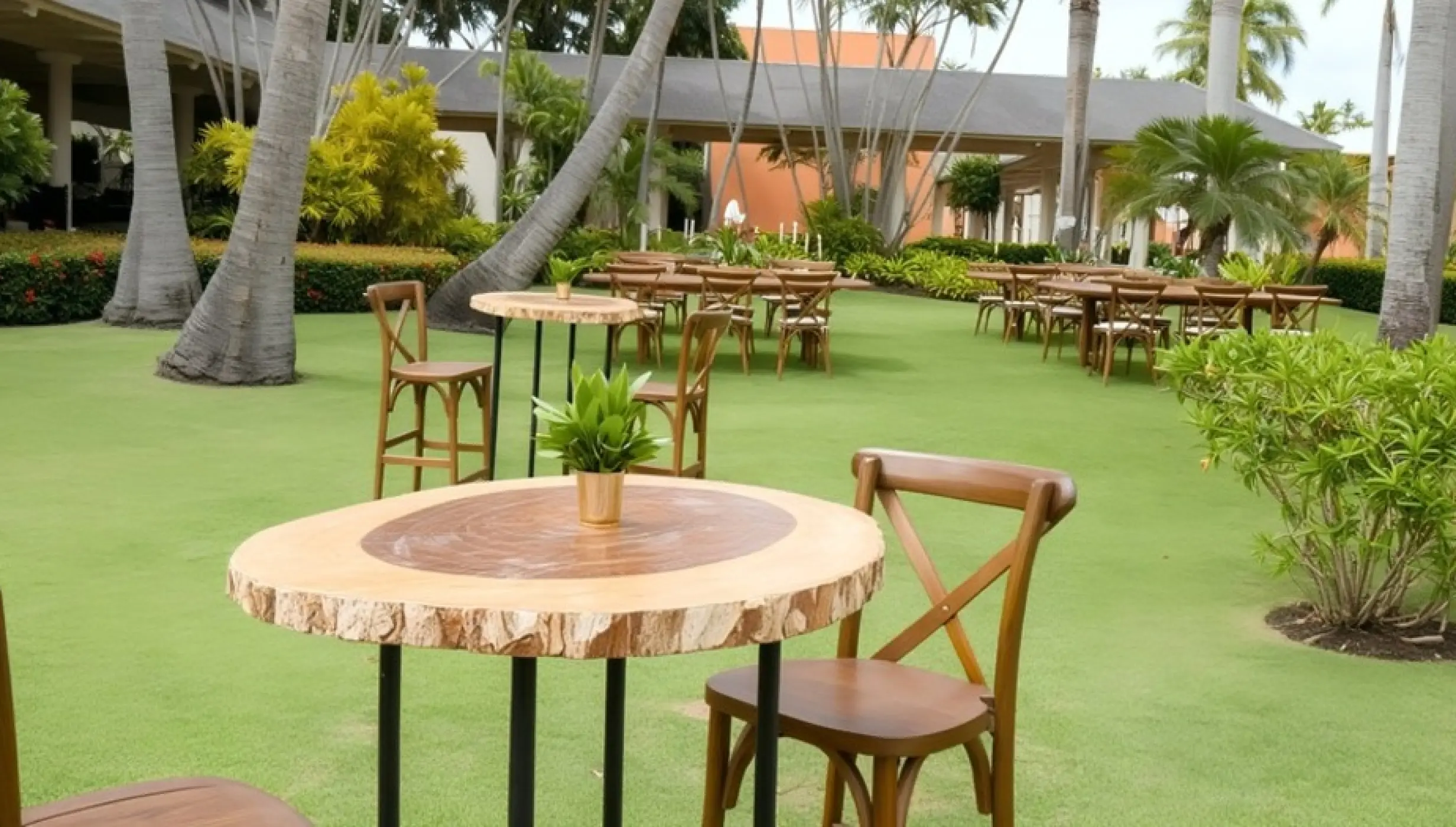 Garden wedding reception with wooden tables and cross-back chairs at Iberostar Waves Dominicana, Punta Cana