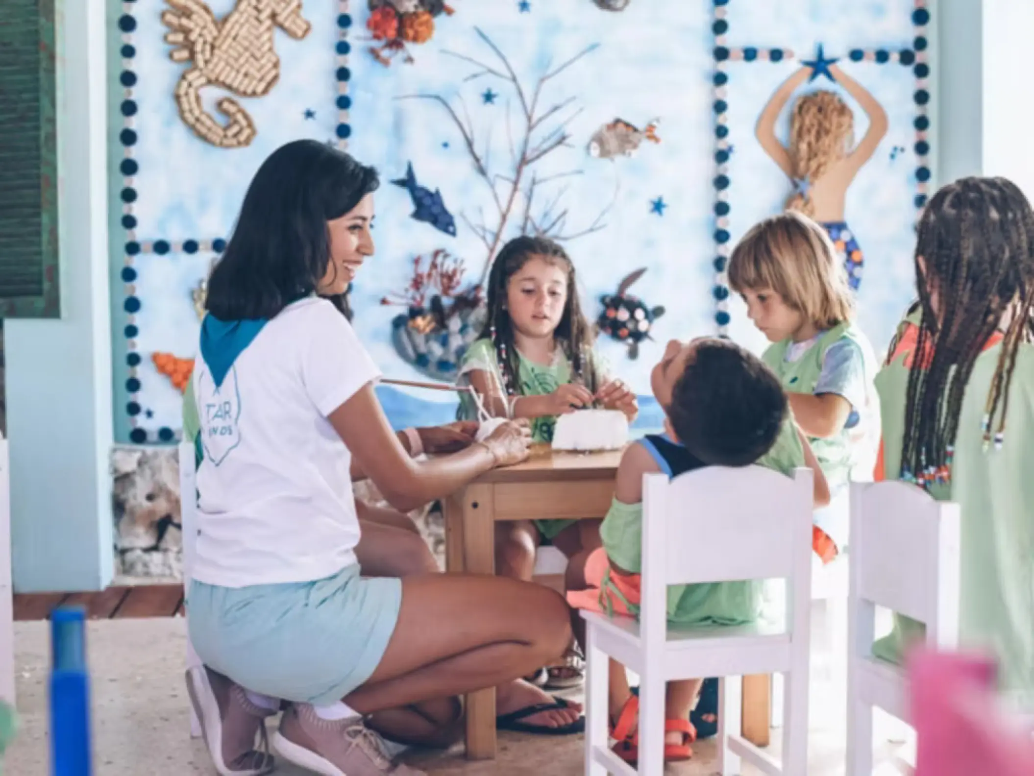 Kids club supervisor doing crafts with children at Iberostar Waves Dominicana, Punta Cana