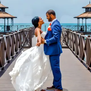Bride and groom posing on the pier at Iberostar Rose Hall Beach, Montego Bay