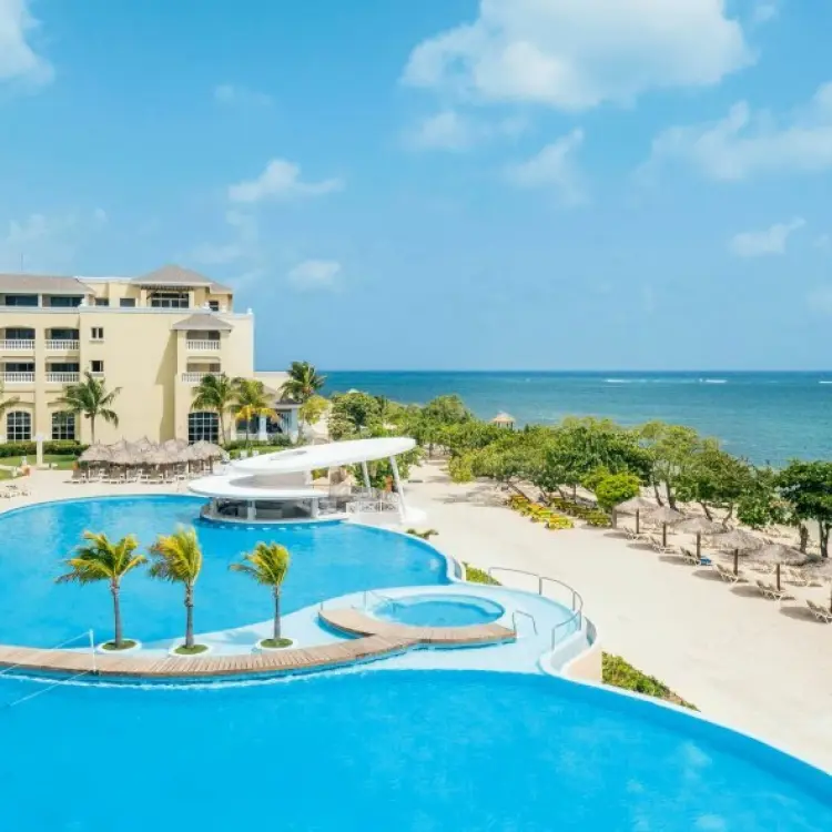 Aerial view of the swimming pools and beachfront at Iberostar Waves Rose Hall Beach, Montego Bay