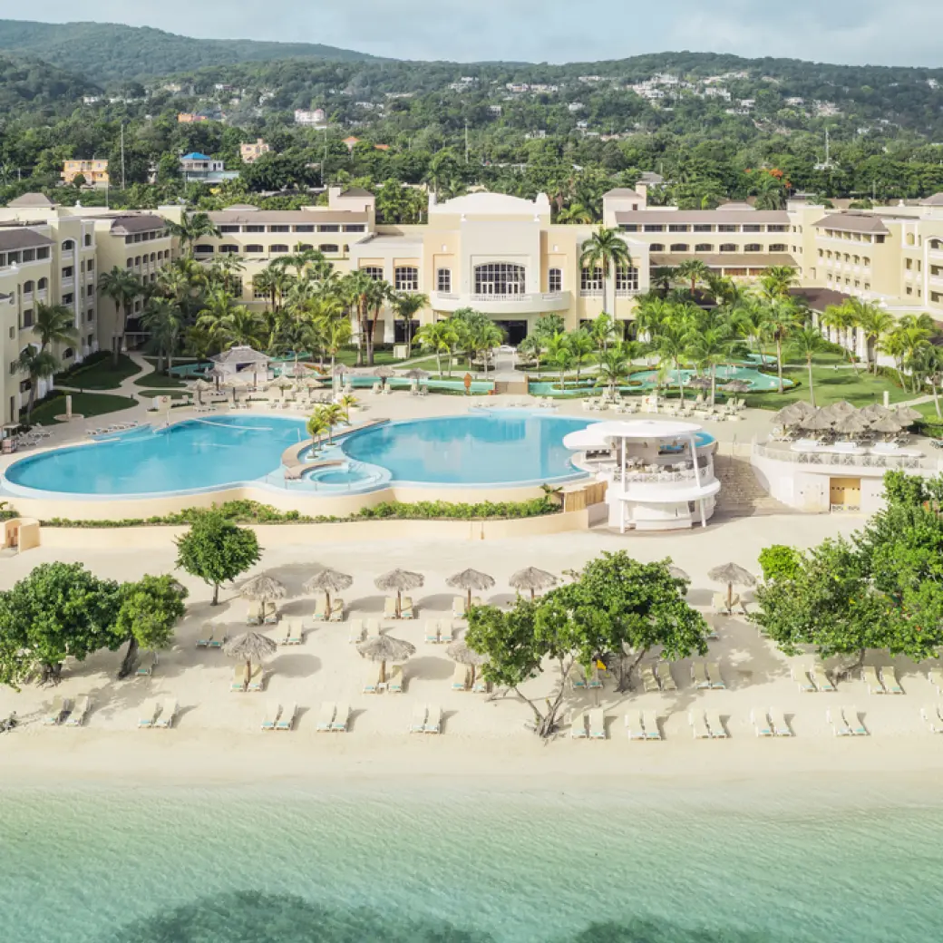 Aerial view of the beachfront pools and tropical grounds at Iberostar Waves Rose Hall Beach, Montego Bay