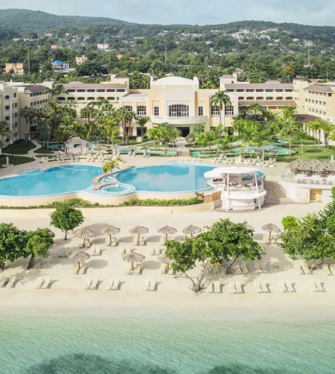 Aerial view of the beachfront pools and tropical grounds at Iberostar Waves Rose Hall Beach, Montego Bay
