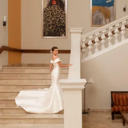 Bride posing on the grand marble staircase at Iberostar Waves Rose Hall Beach, Montego Bay