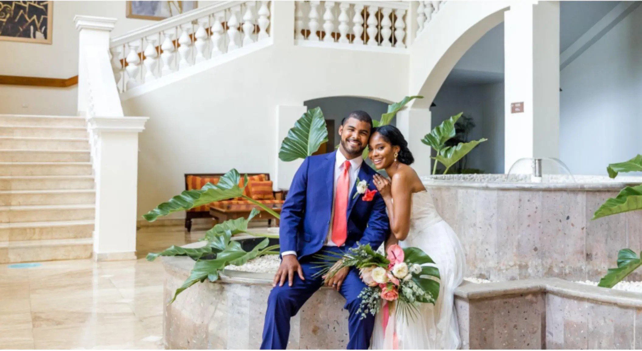 Bride and groom portrait by the marble staircase at Iberostar Waves Rose Hall Beach, Montego Bay