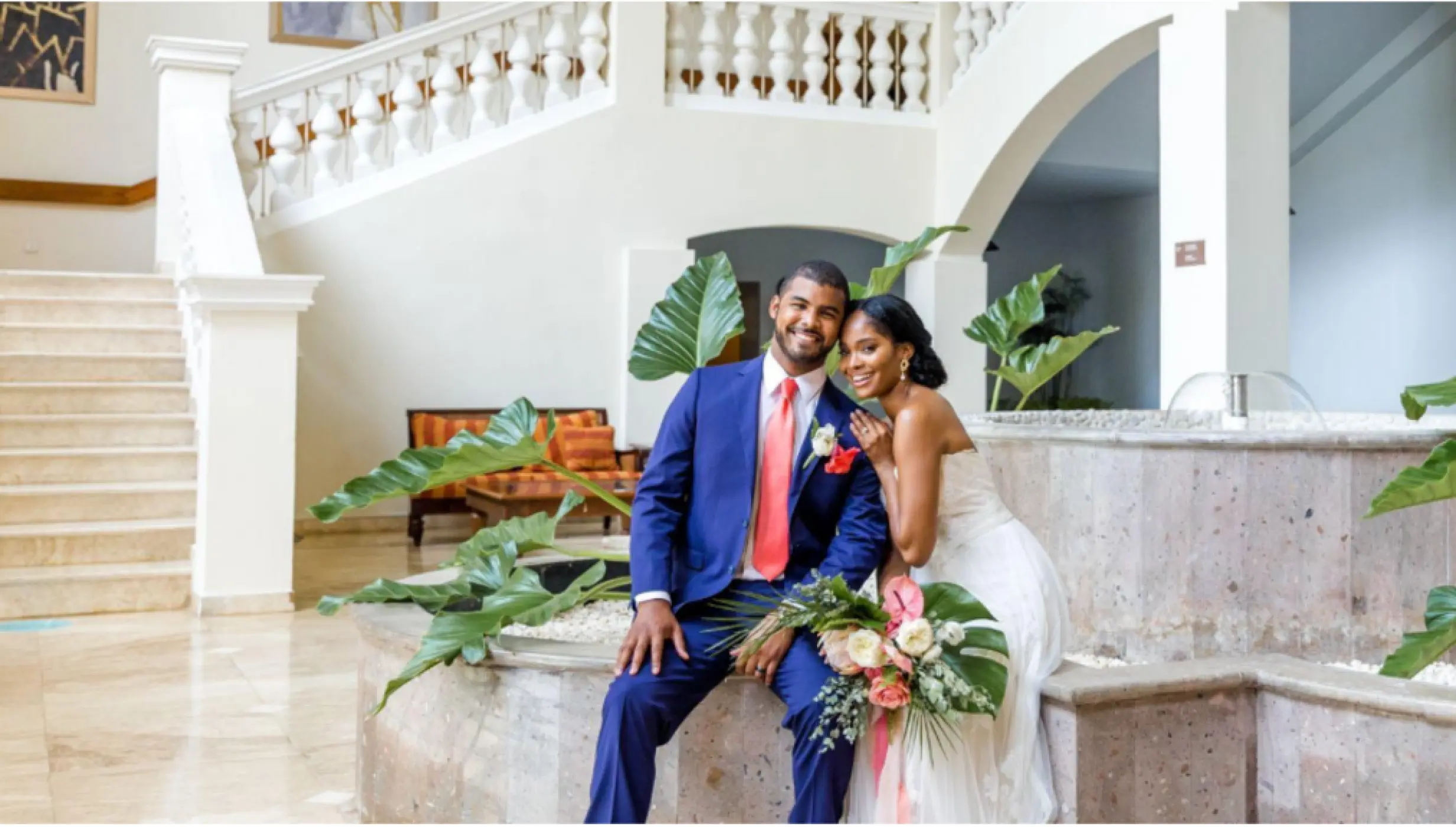 bride and groom at the marble staircase venue at Iberostar Waves Rose Hall Beach