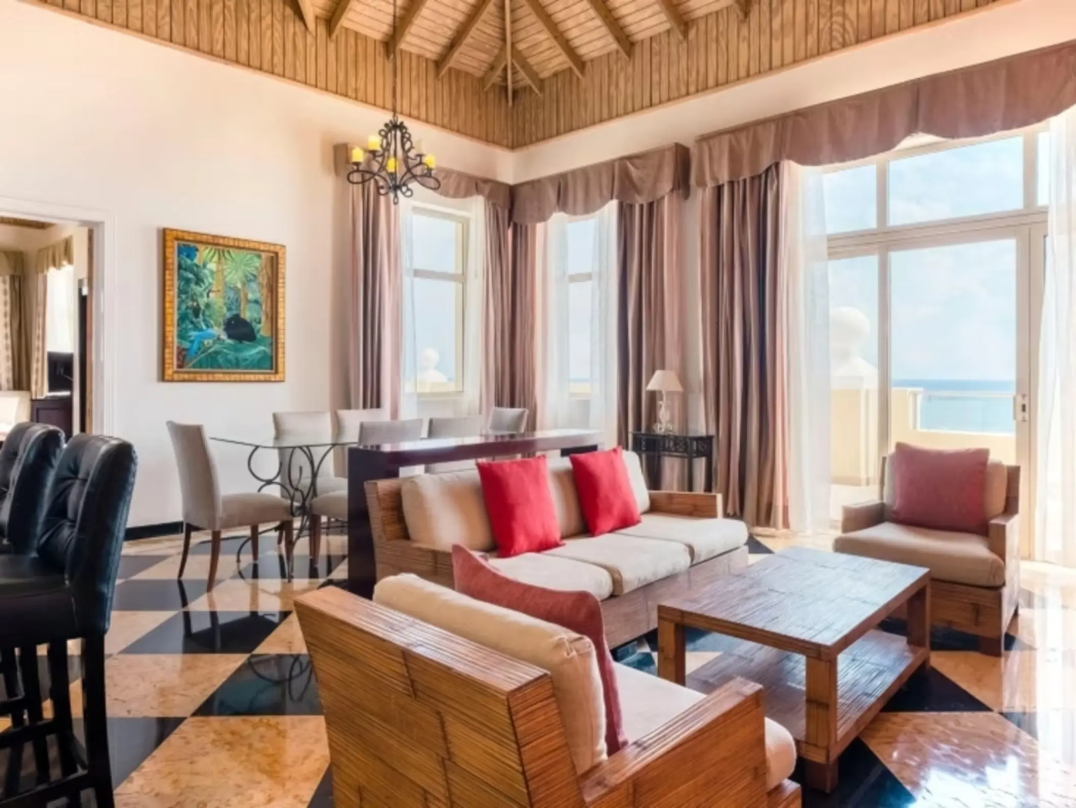 Oceanview suite living area with high ceilings and large windows at Iberostar Rose Hall Beach, Montego Bay
