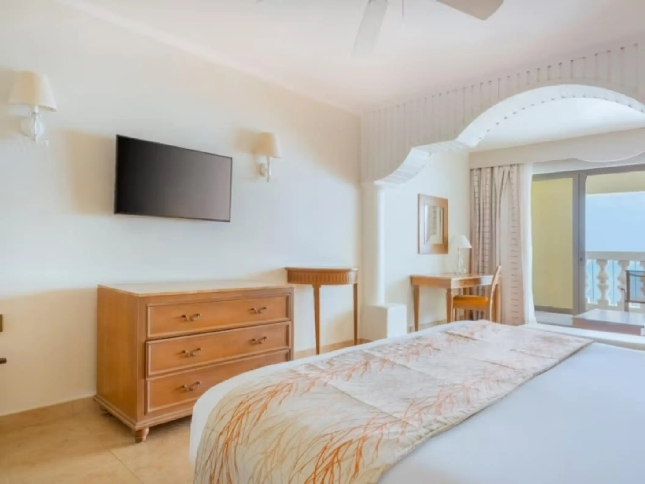 Bright guest room with a large bed and balcony at Iberostar Waves Rose Hall Beach, Montego Bay