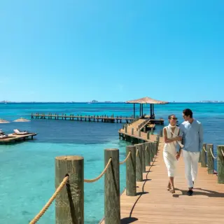 Couple walking along the wooden pier at Impression Isla Mujeres, Isla Mujeres