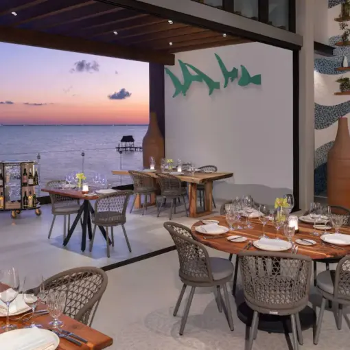 Spezia Restaurant open-air dining tables overlooking the ocean at sunset, Impression Isla Mujeres