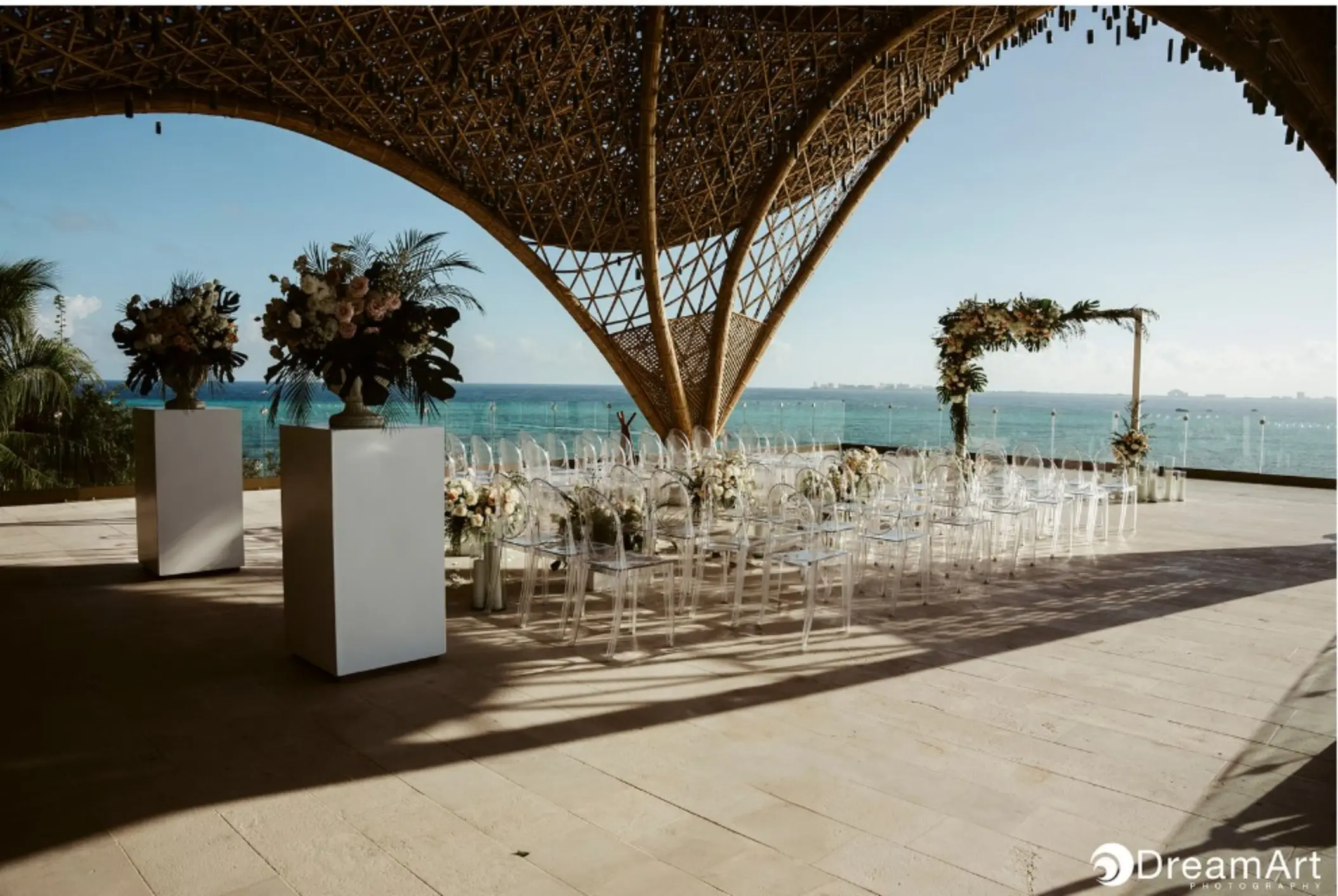 Temple wedding ceremony with ghost chairs at Impression Isla Mujeres by Secrets, Isla Mujeres