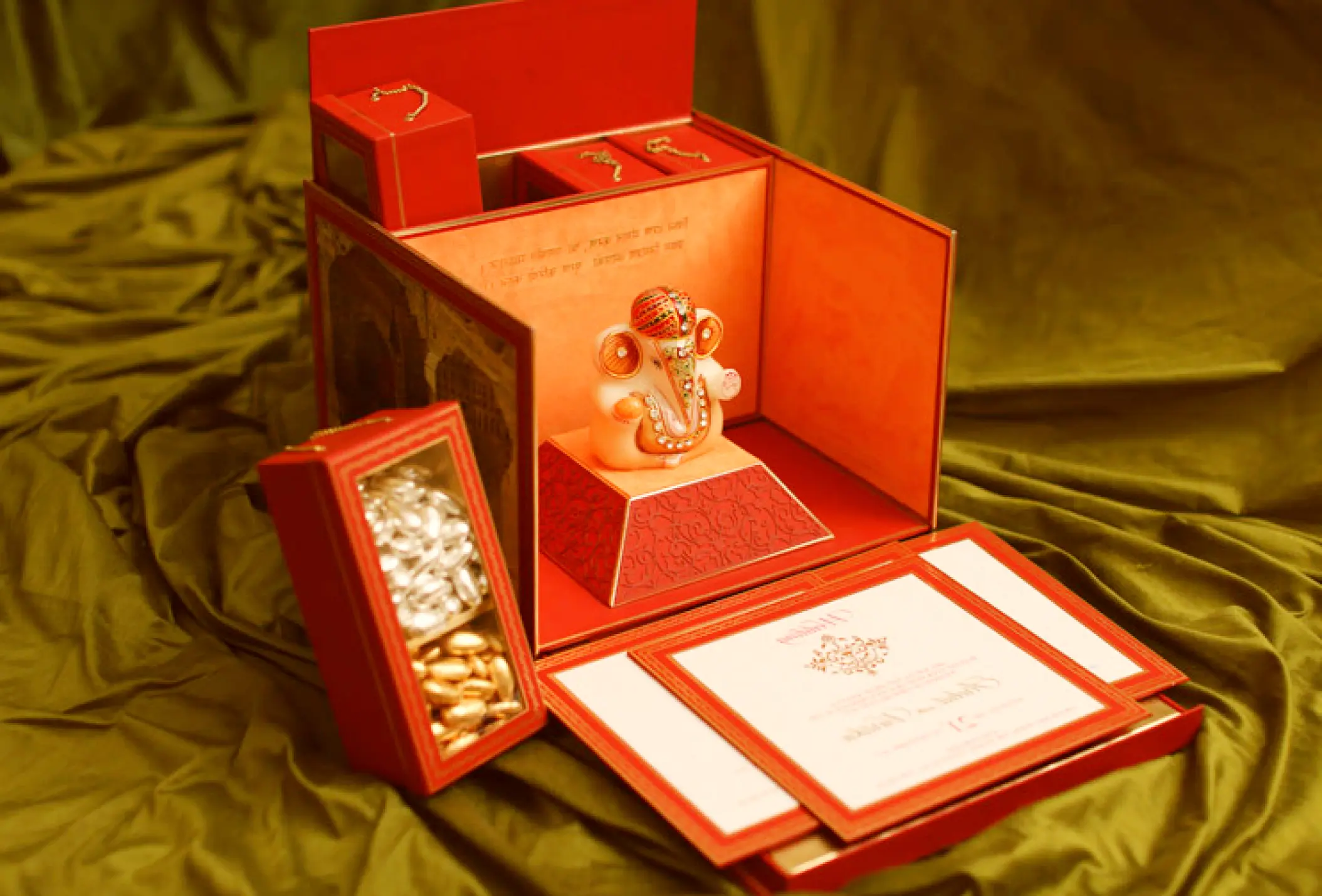 Traditional Indian wedding invitation box with a Ganesha figurine and sweets for a Secrets Tides Punta Cana wedding