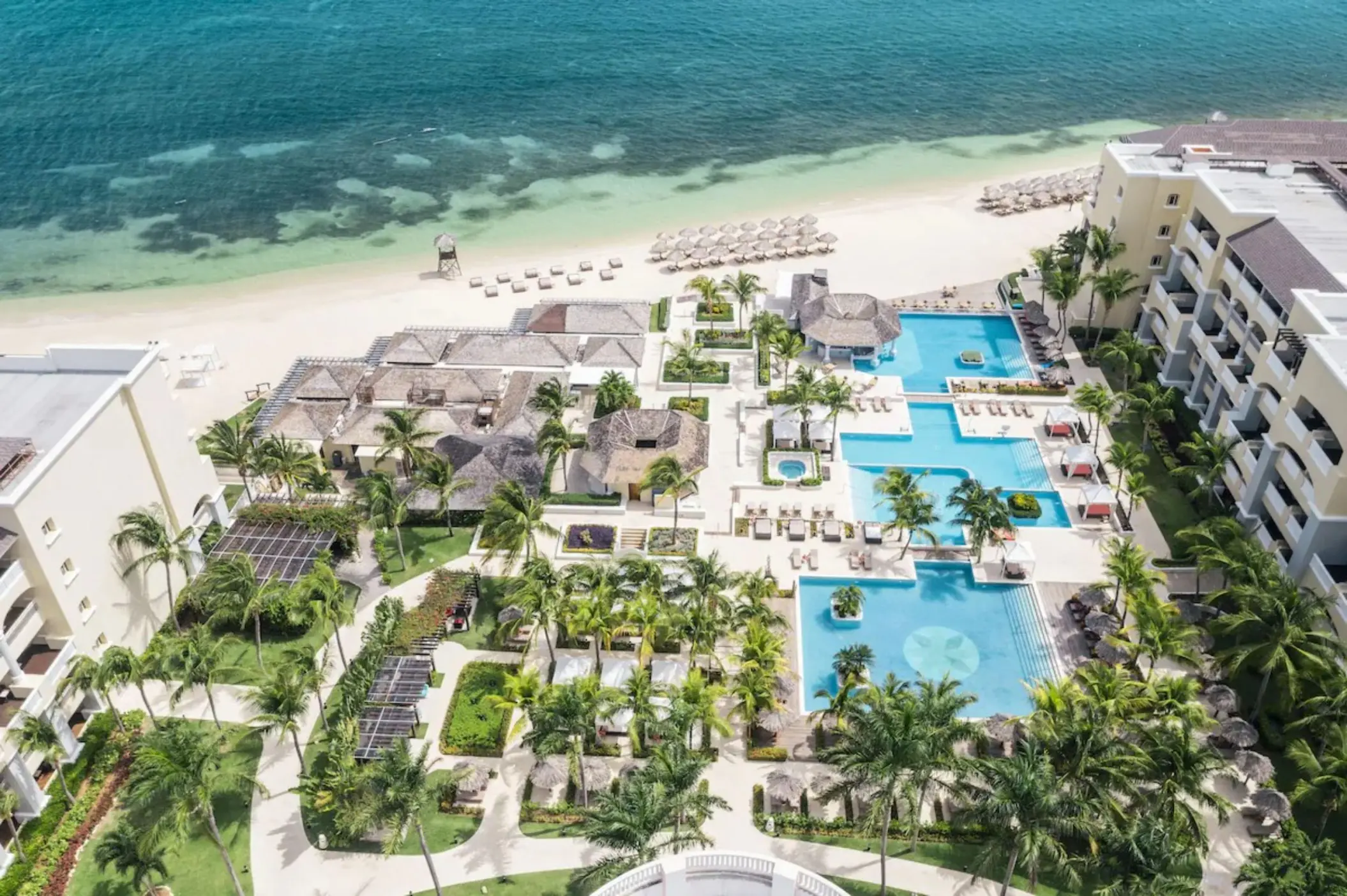 Aerial view of the pools, beachfront, and grounds at JOIA Rose Hall by Iberostar, Montego Bay