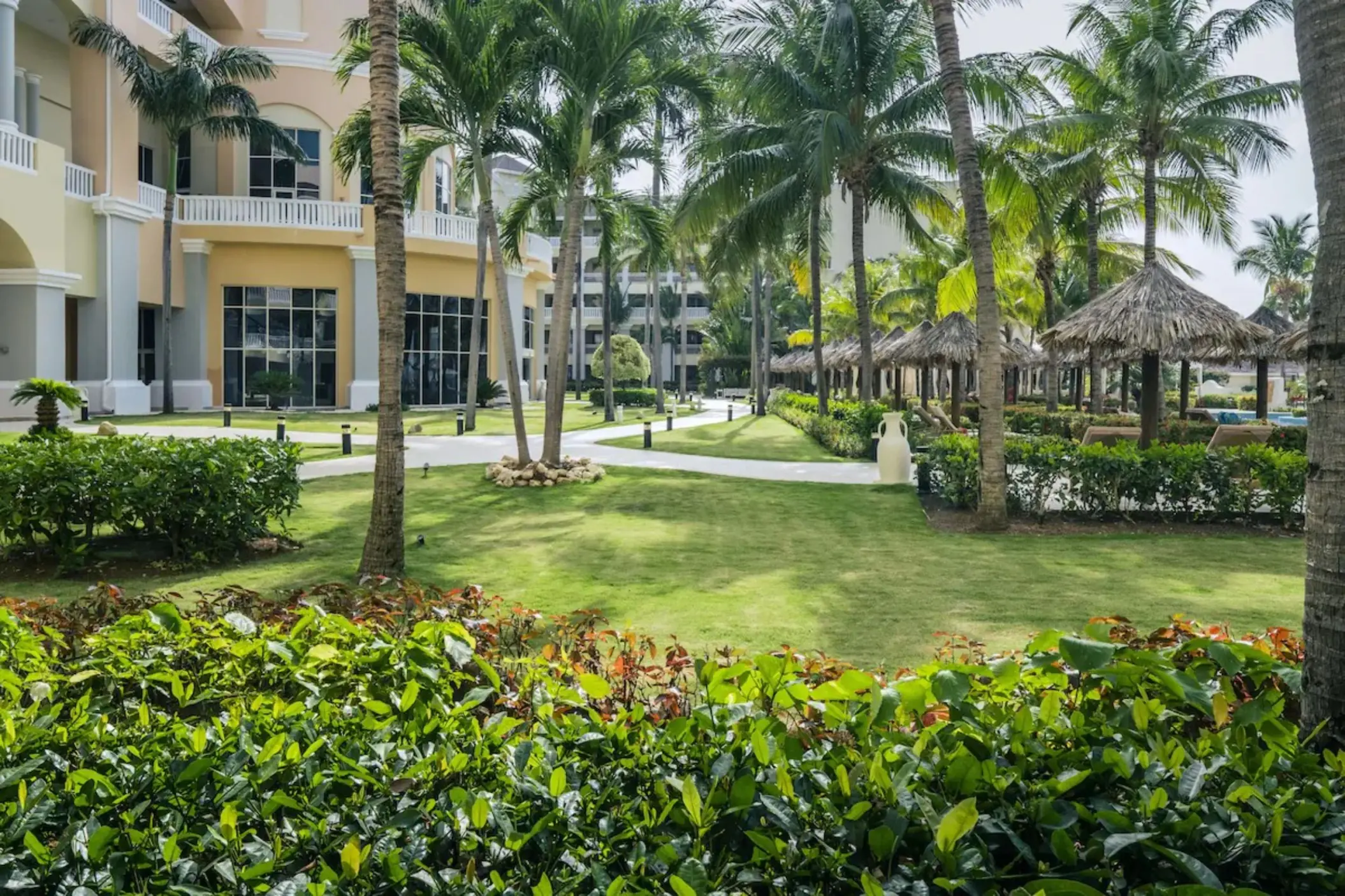Palm tree lined garden pathways and tropical landscaping at JOIA Rose Hall, Montego Bay
