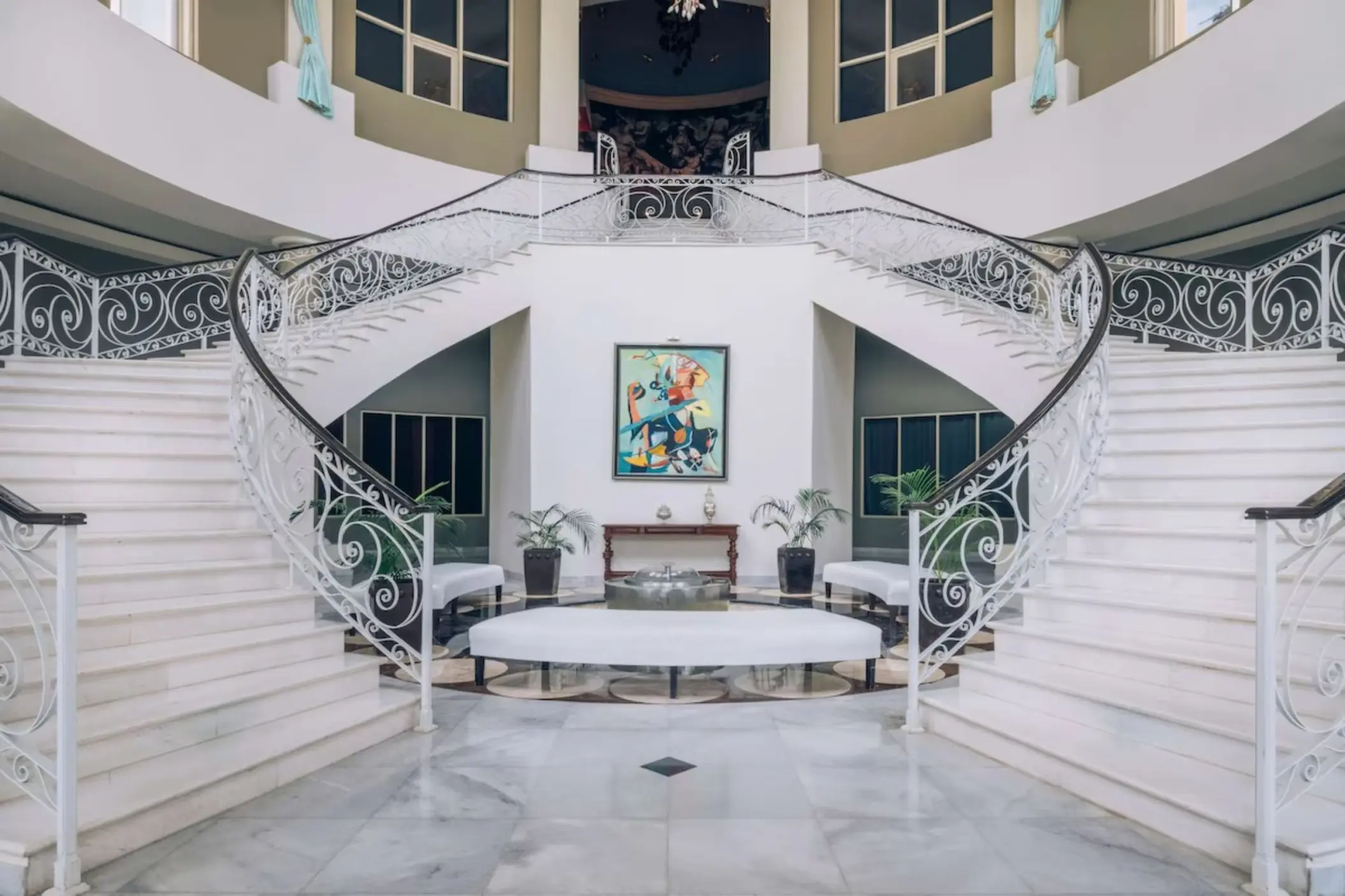 Grand staircase with ornate white railings at JOIA Rose Hall by Iberostar, Montego Bay
