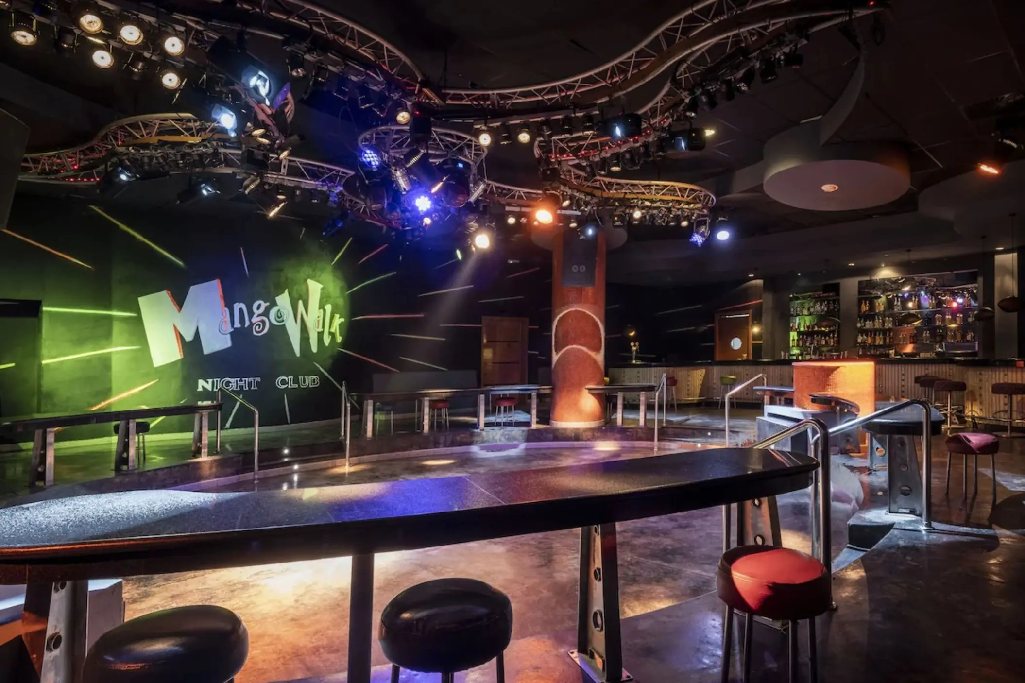 Mango Walk night club with stage lighting and bar seating at JOIA Rose Hall, Montego Bay