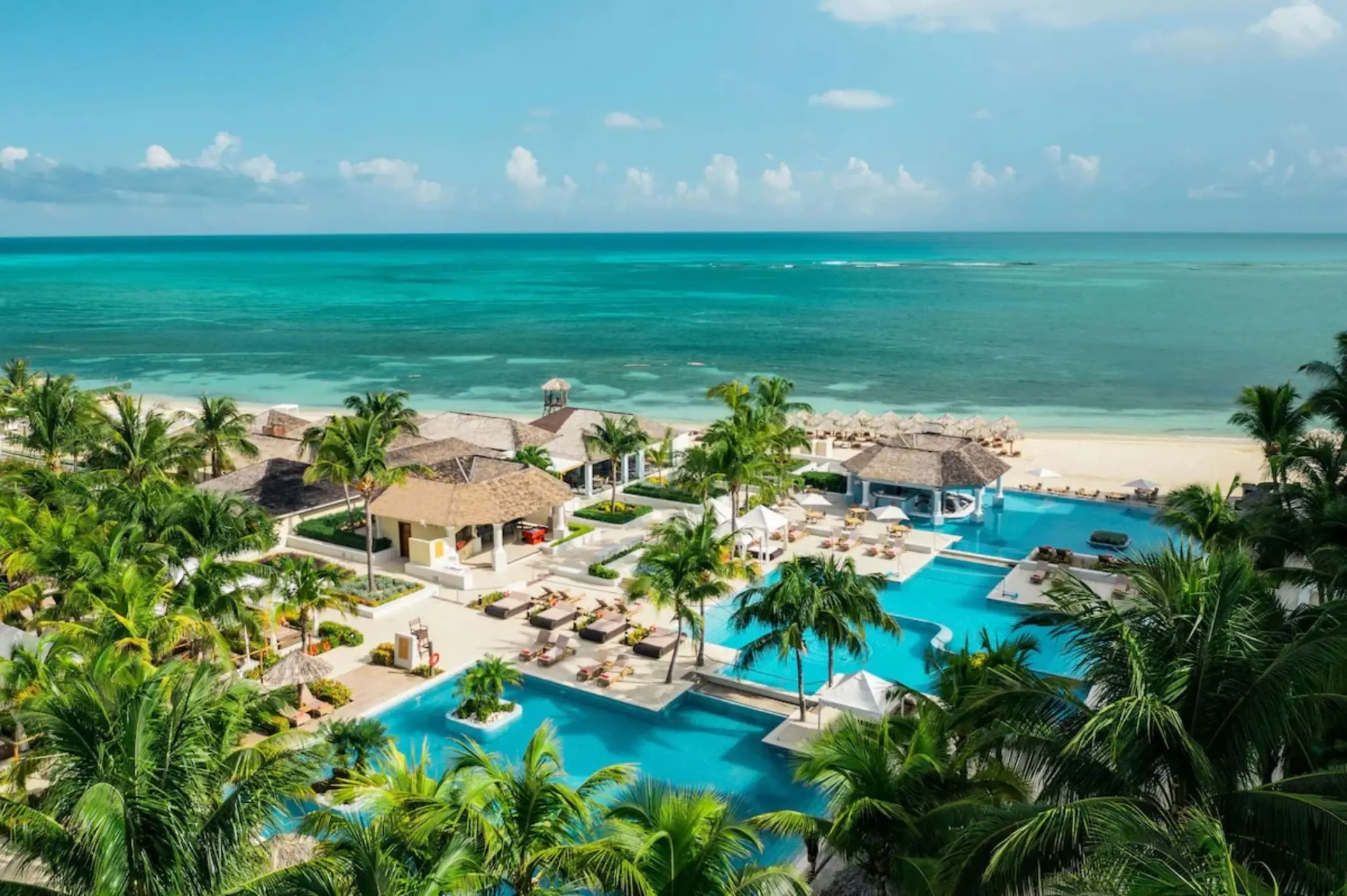 JOIA Rose Hall beachfront swimming pools and palm trees, Montego Bay