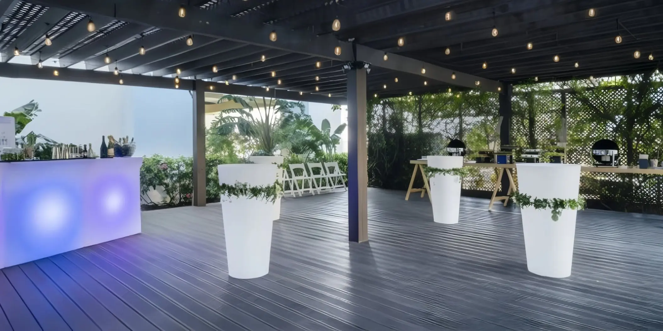 Cocktail reception setup on the JOIA Rose Hall garden deck with string lights, Montego Bay