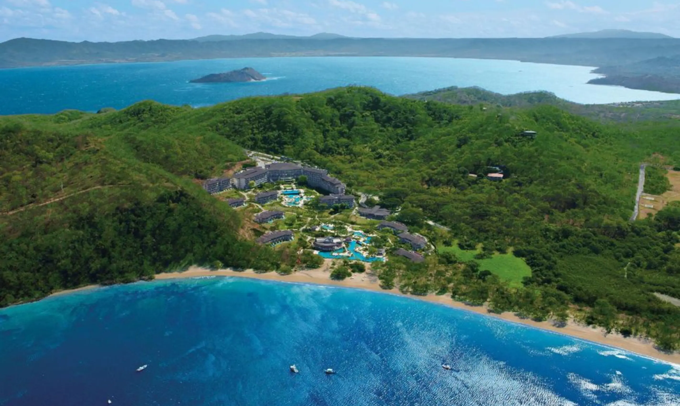 Aerial view of JW Marriott Costa Elena nestled in lush hills by the ocean, El Jobo