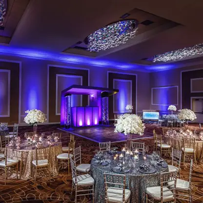 Indoor wedding reception with purple lighting and floral centerpieces at Margaritaville Riviera Cancun, Cancun
