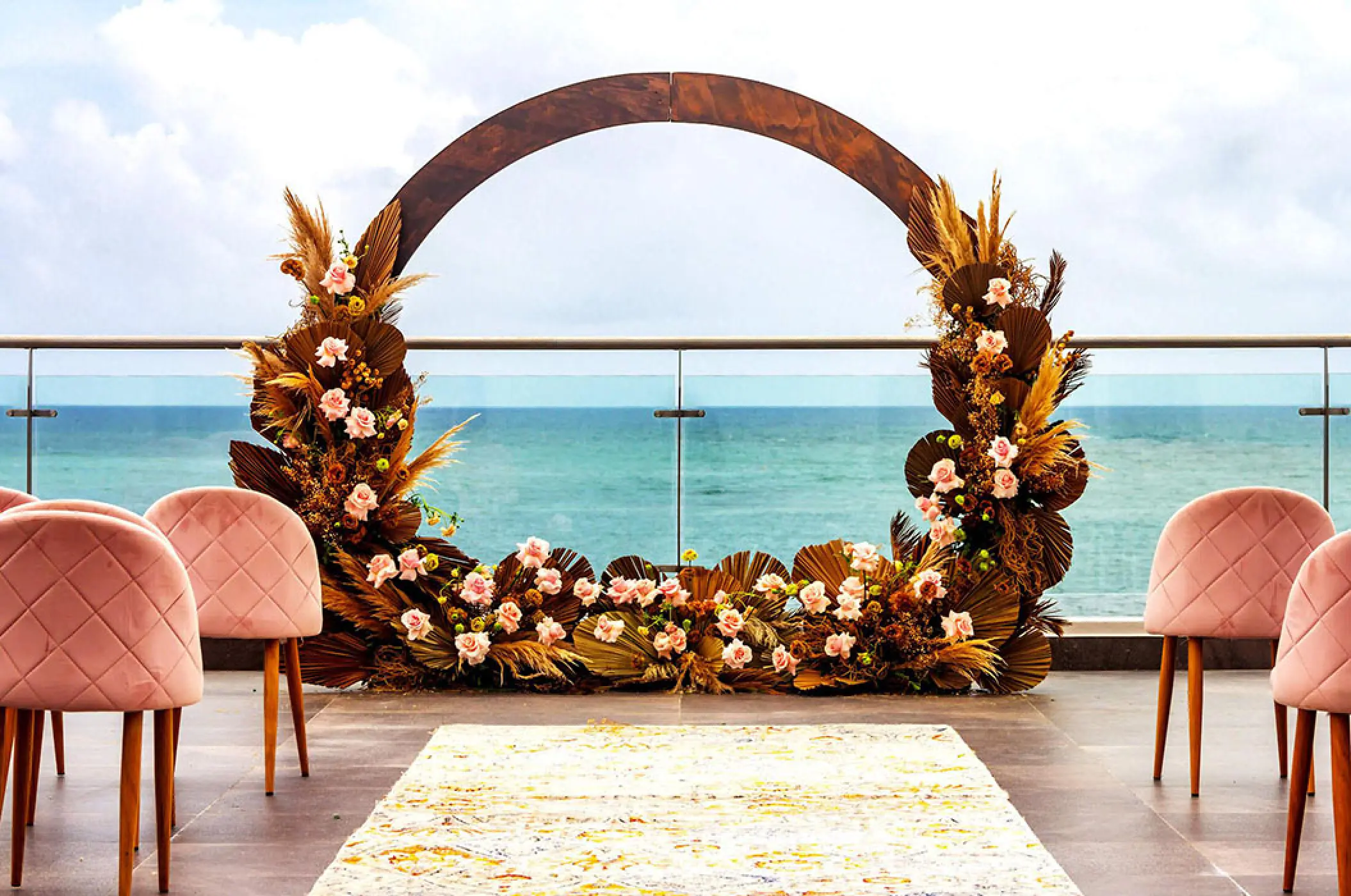 Floral circular arch for a sky wedding ceremony at Margaritaville Island Reserve Riviera Maya