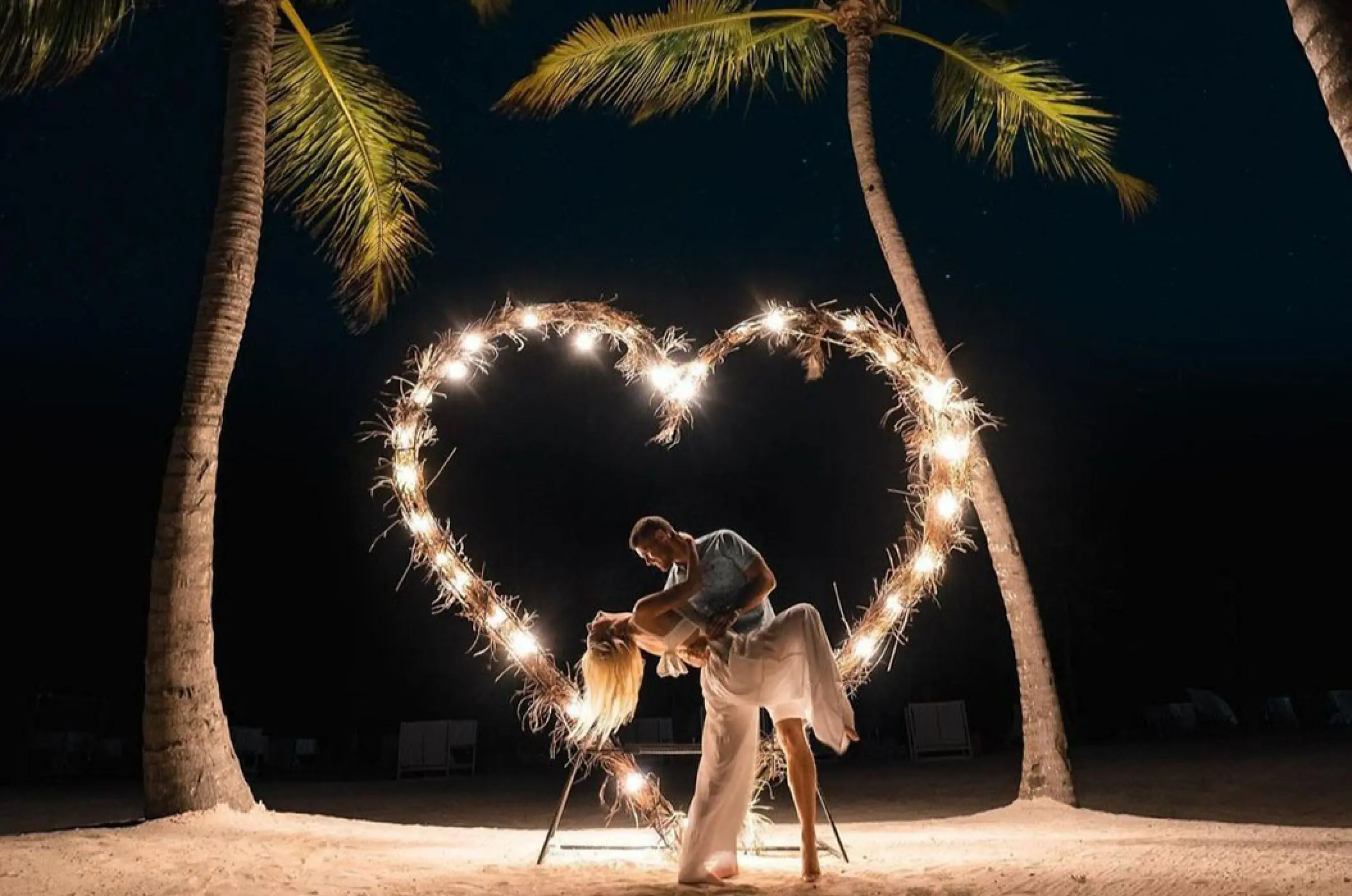 The bride and groom dancing inside a lighted heart at night, Margaritaville Island Reserve Cap Cana
