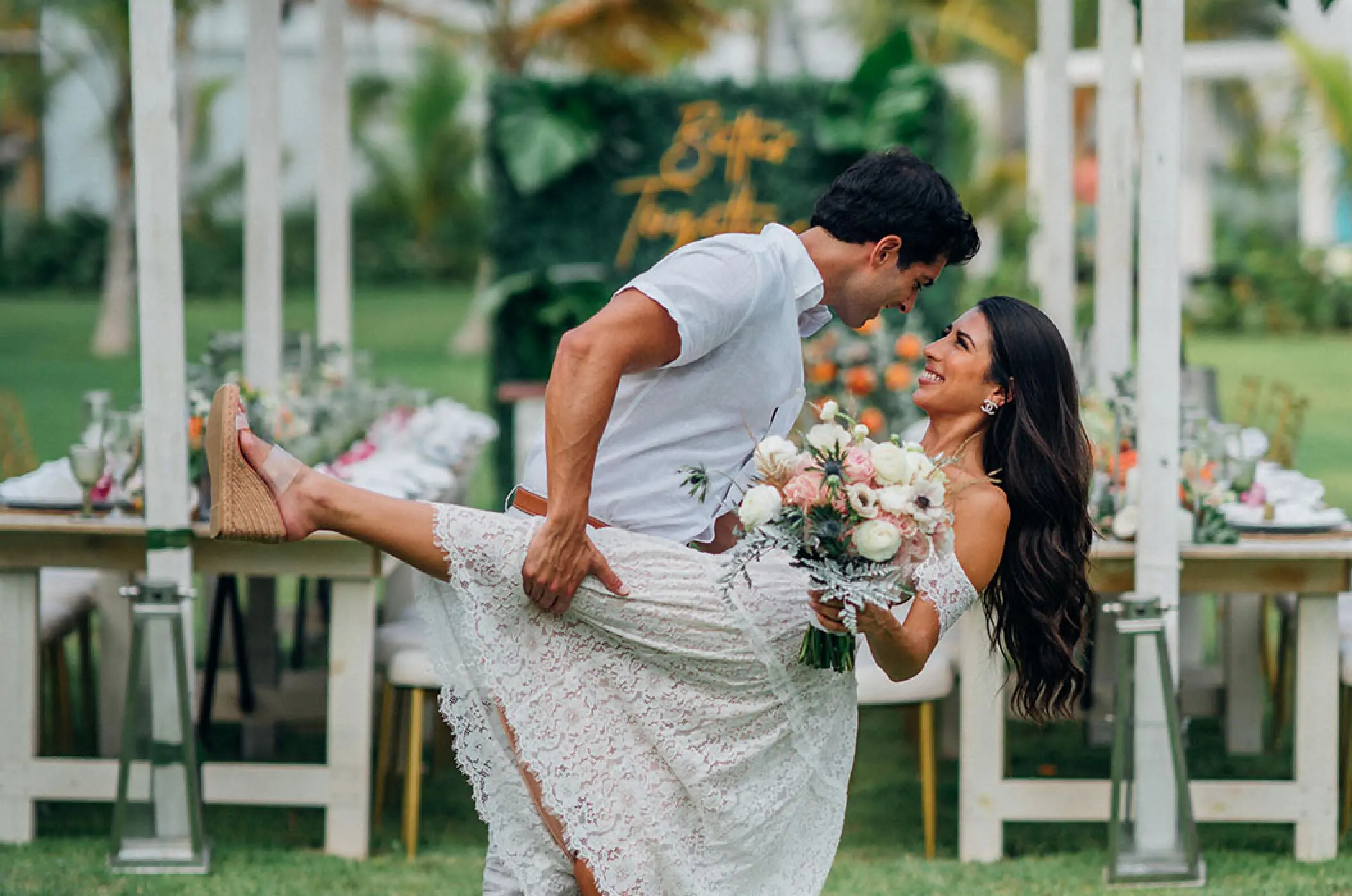Groom dipping the bride during their outdoor reception at Margaritaville Island Reserve Cap Cana, Punta Cana