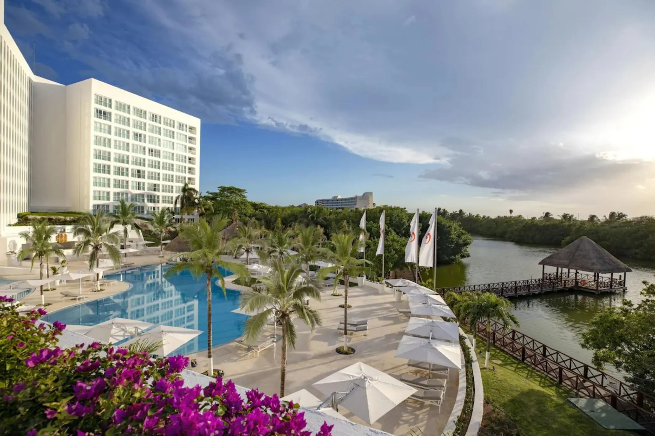 Le Blanc Spa Resort Cancun outdoor pool and lagoon terrace with white umbrellas, Cancun