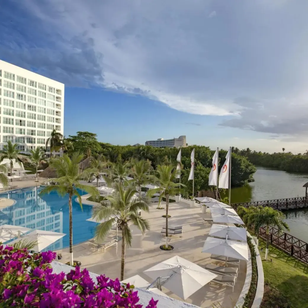 Le Blanc Spa Resort Cancun outdoor pool and lagoon terrace with white umbrellas, Cancun