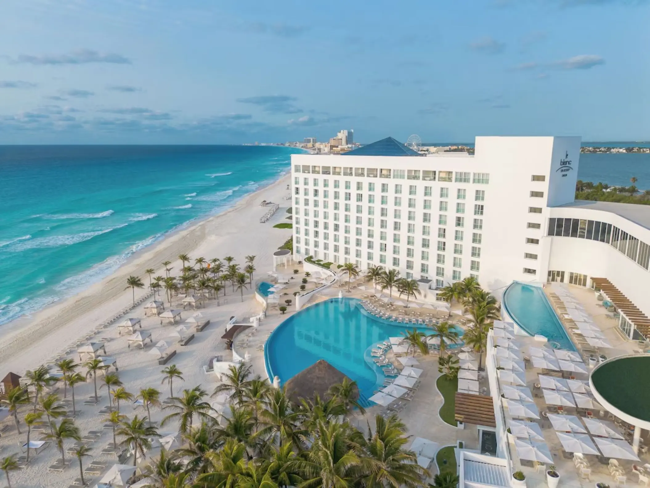 Aerial view of Le Blanc Spa Resort beachfront pools and white sand beach in Cancun
