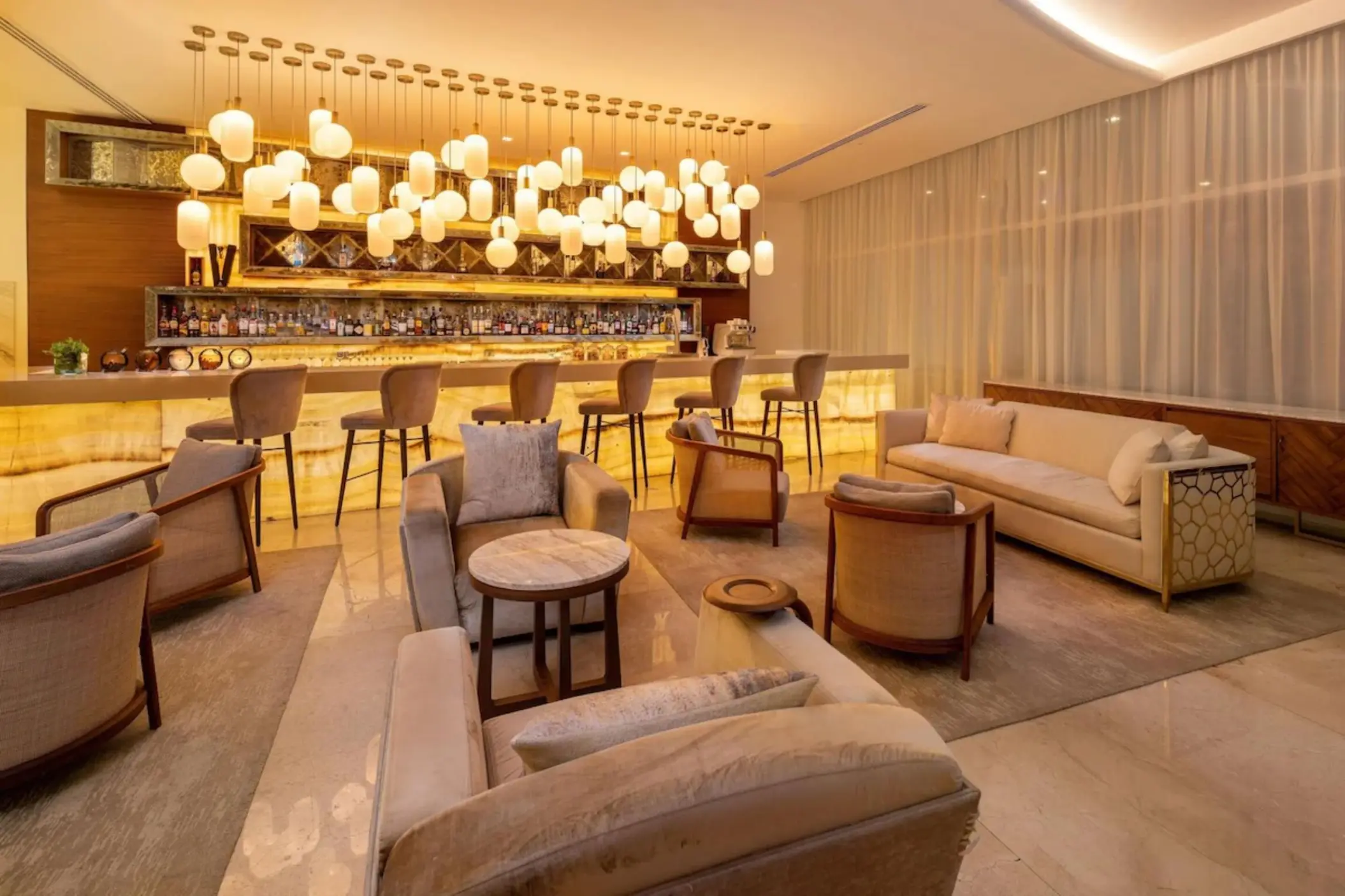 Modern bar lounge with warm lighting at Le Blanc Cancun