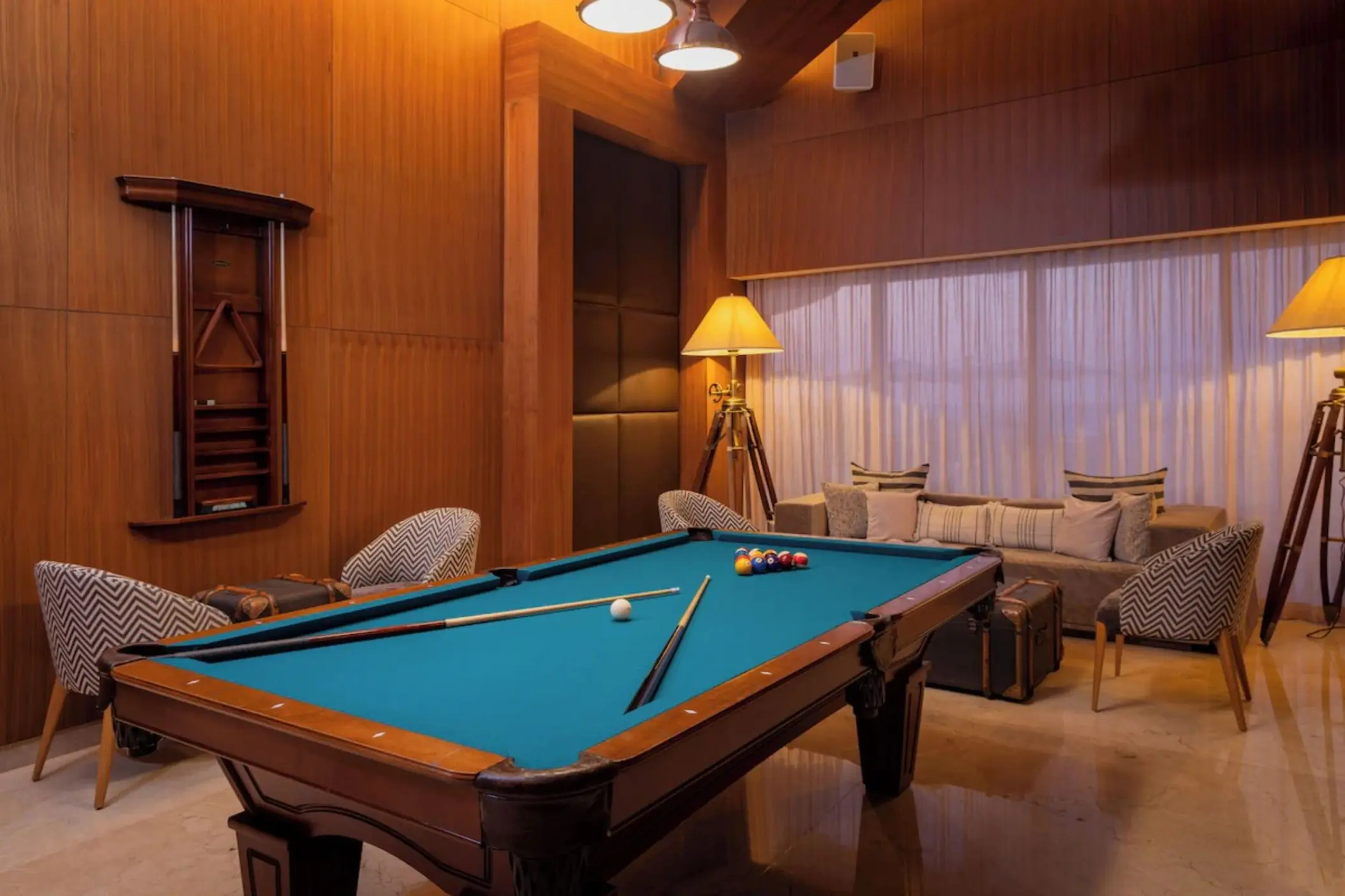 Billiards room with a blue pool table and wood-paneled walls at Le Blanc Spa Resort, Cancun